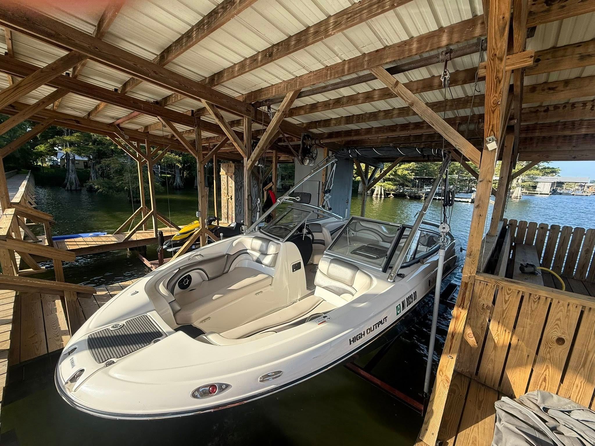 2008 Yamaha 212X boat in covered dock.