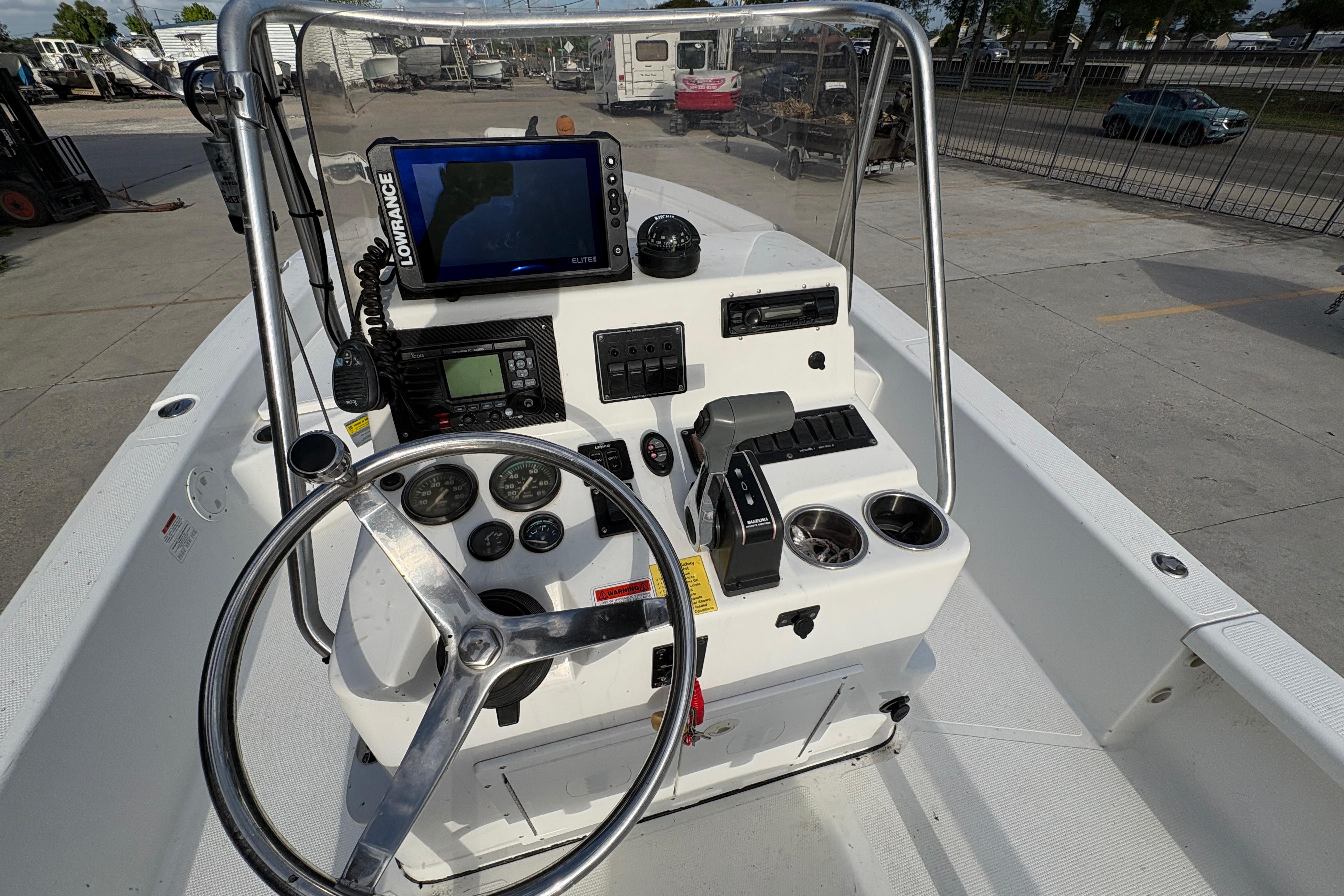 2012 BlackJack 224 boat console with steering wheel, gauges, and navigation equipment.