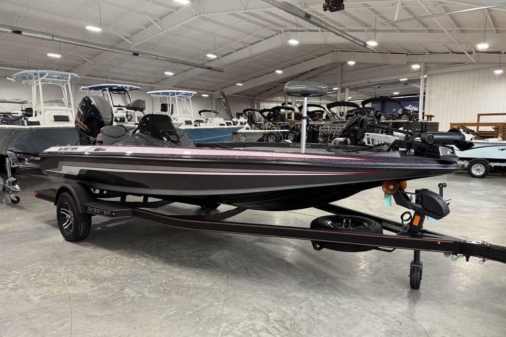 2025 Skeeter ZX150 boat in showroom, sleek design, black finish, on trailer.