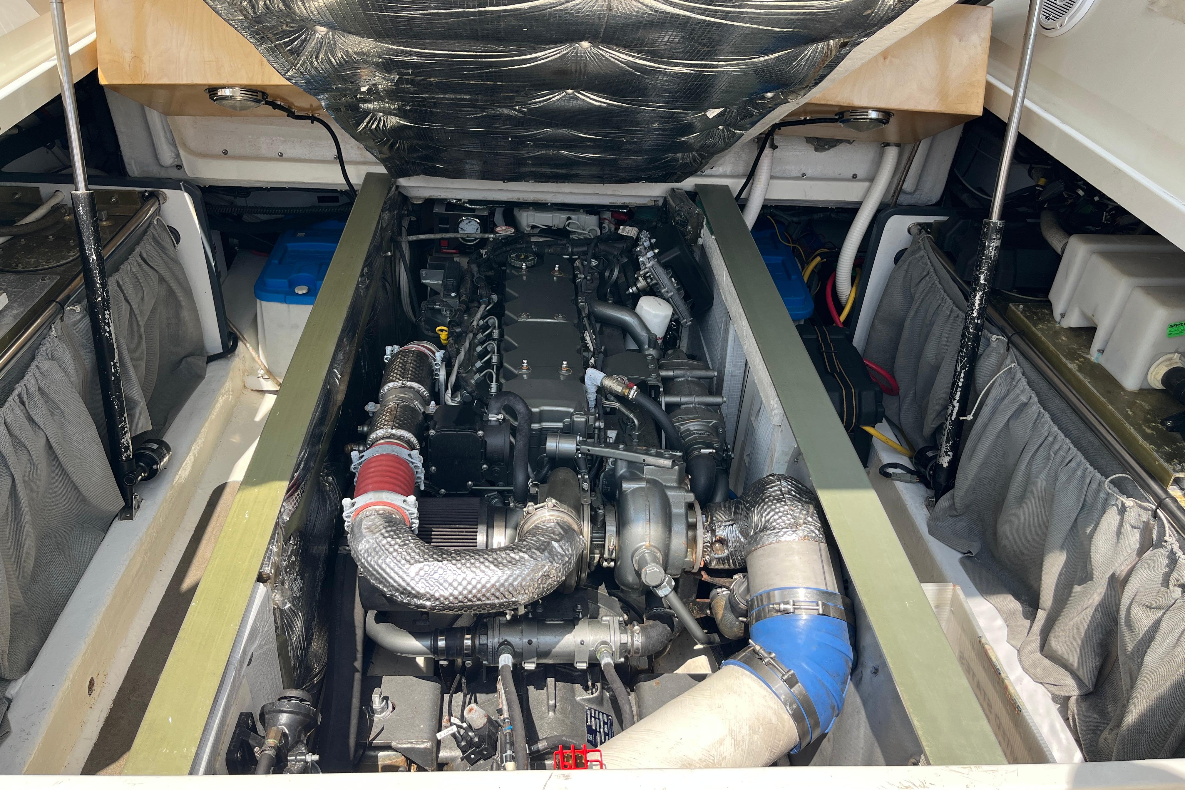 Engine compartment of a 2006 MJM 34z boat, showcasing detailed mechanical components.