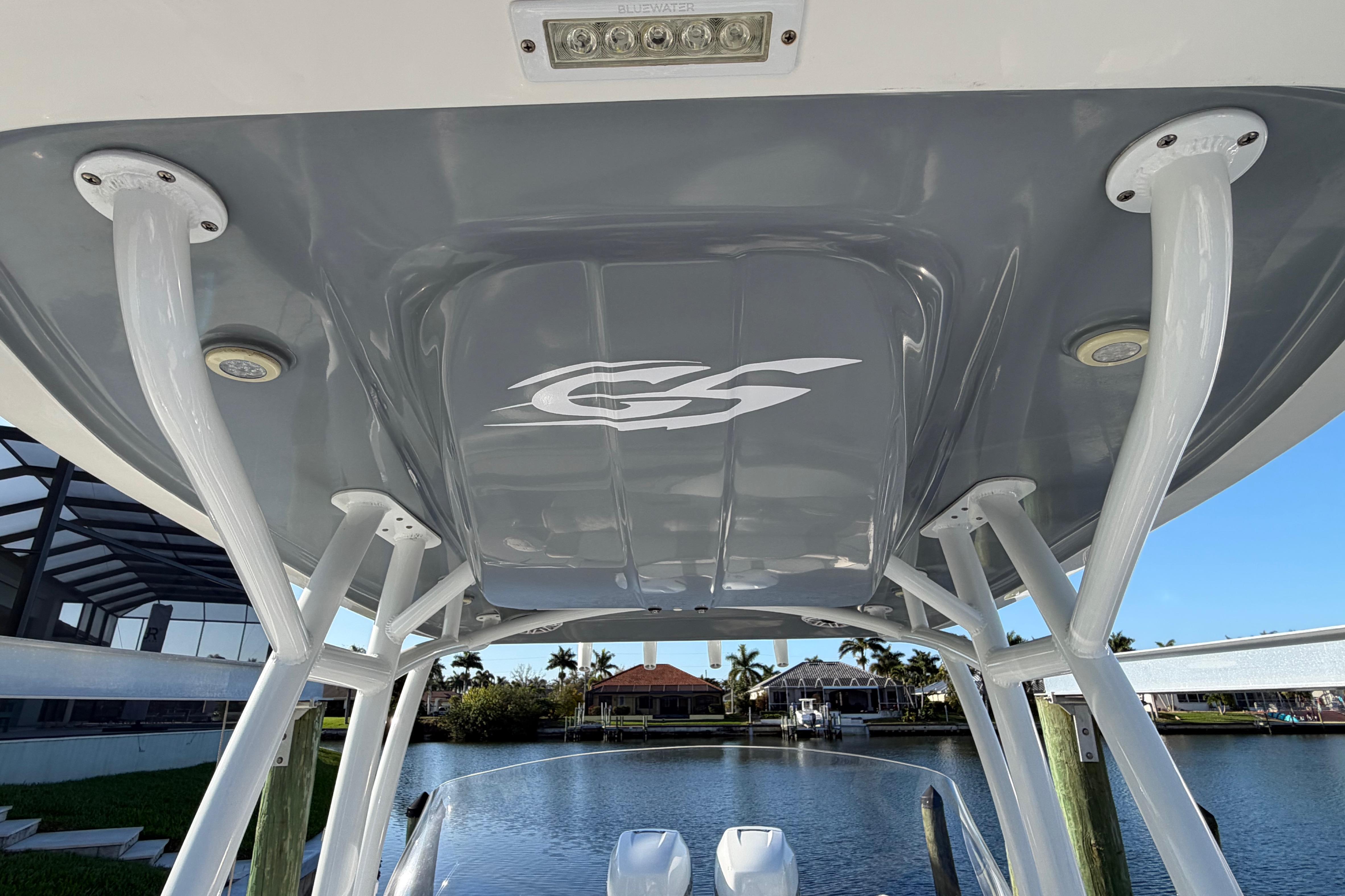 2022 Glasstream 328 Pro-XS boat canopy with logo, overlooking waterfront homes.