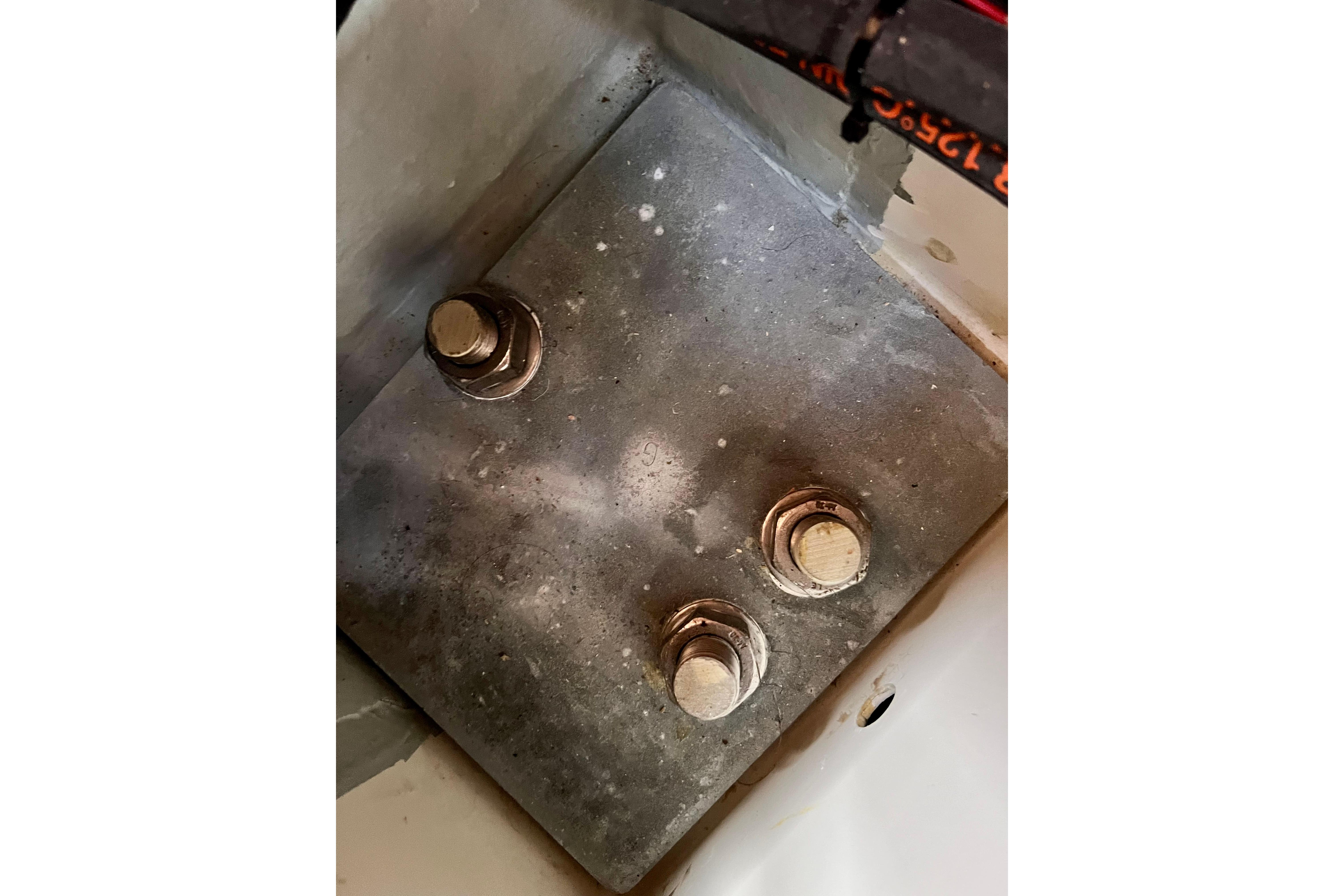Close-up of a metal plate with bolts on a 2016 Hanse 455 yacht.