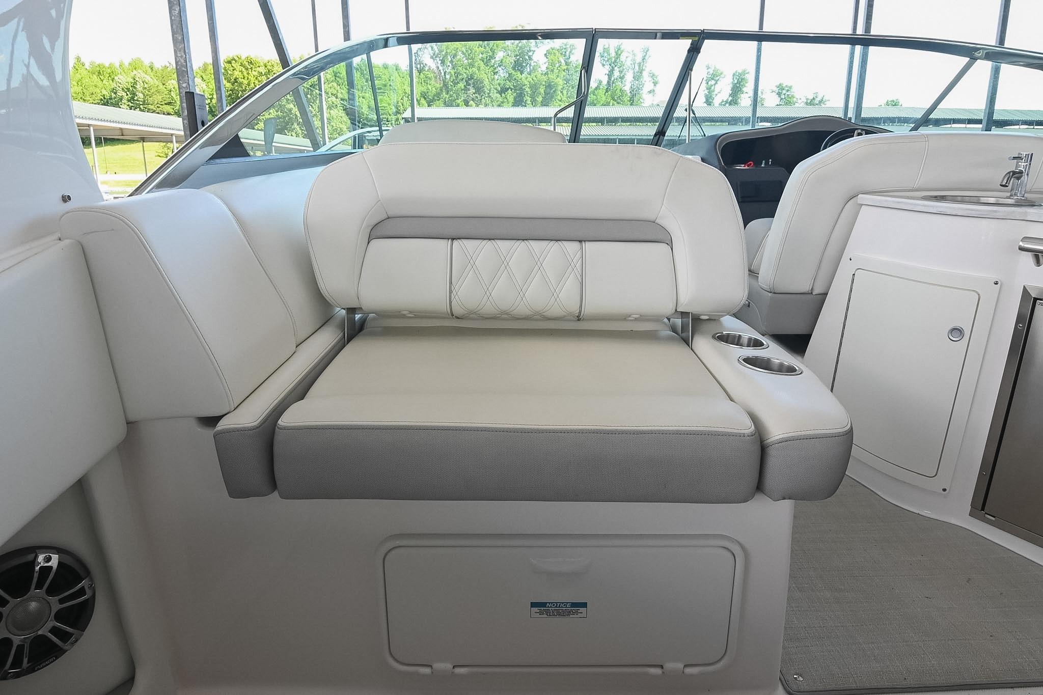 2021 Regal 33 Express boat interior with cushioned seating and cup holders.