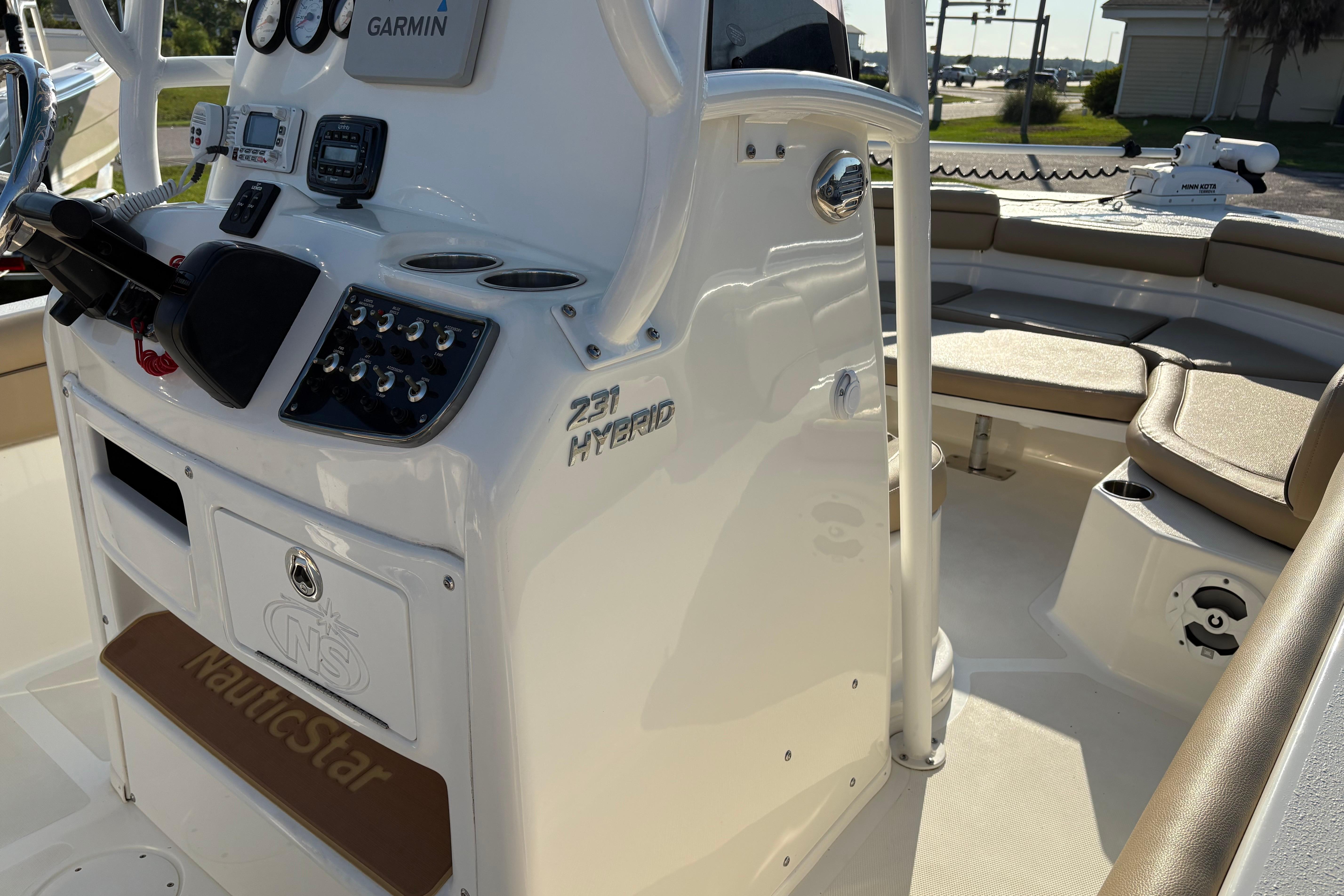 2019 NauticStar 231 Hybrid boat interior with Garmin electronics and seating area.