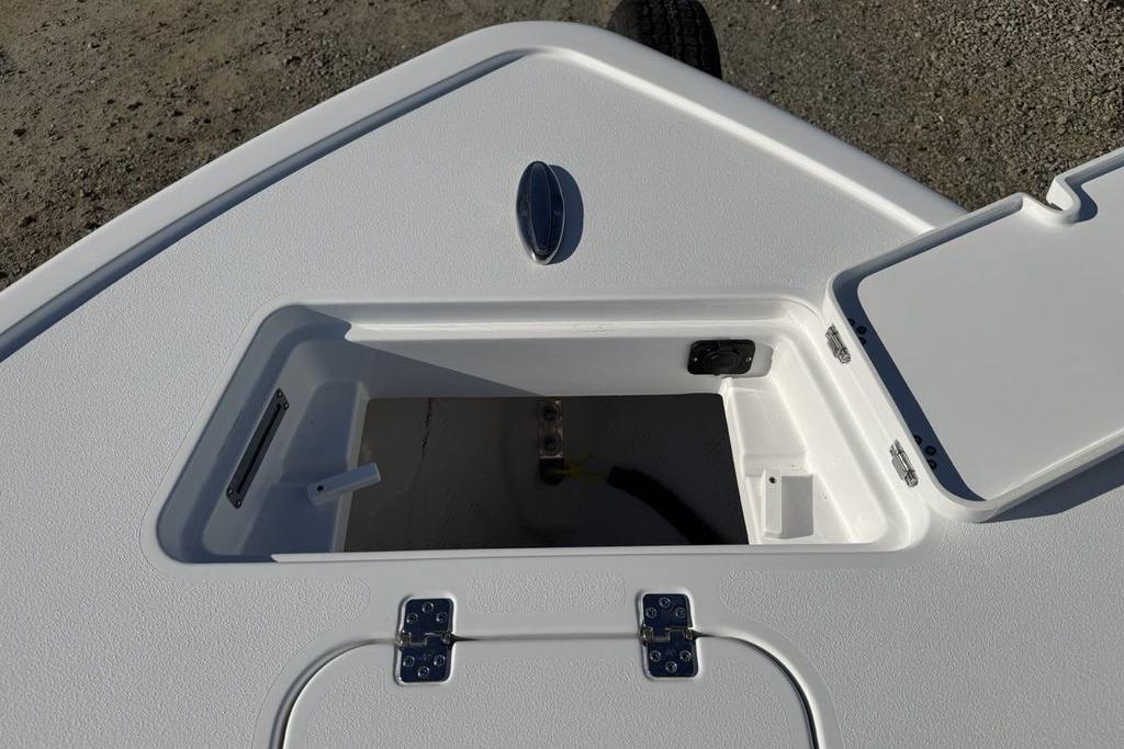 2026 Sportsman Masters 247OE Bay Boat storage compartment with open hatch on deck.