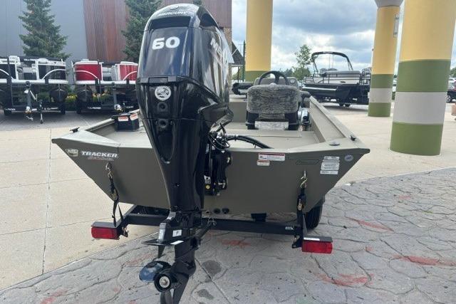 2026 Tracker Grizzly 1754 SC boat with 60 HP motor, parked outdoors.