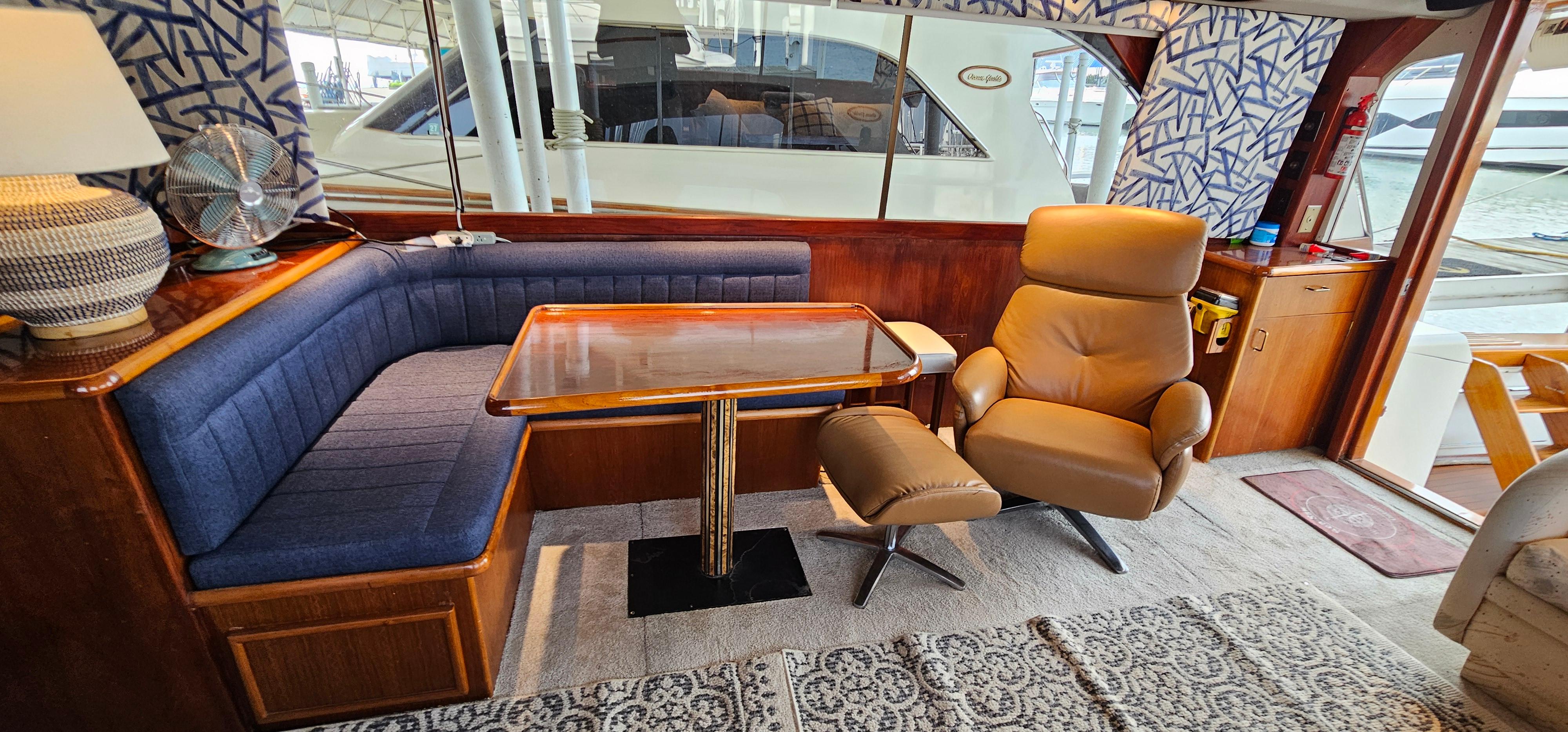 Interior of 1987 Ocean Yachts 48 Super Sport with seating, table, and recliner.
