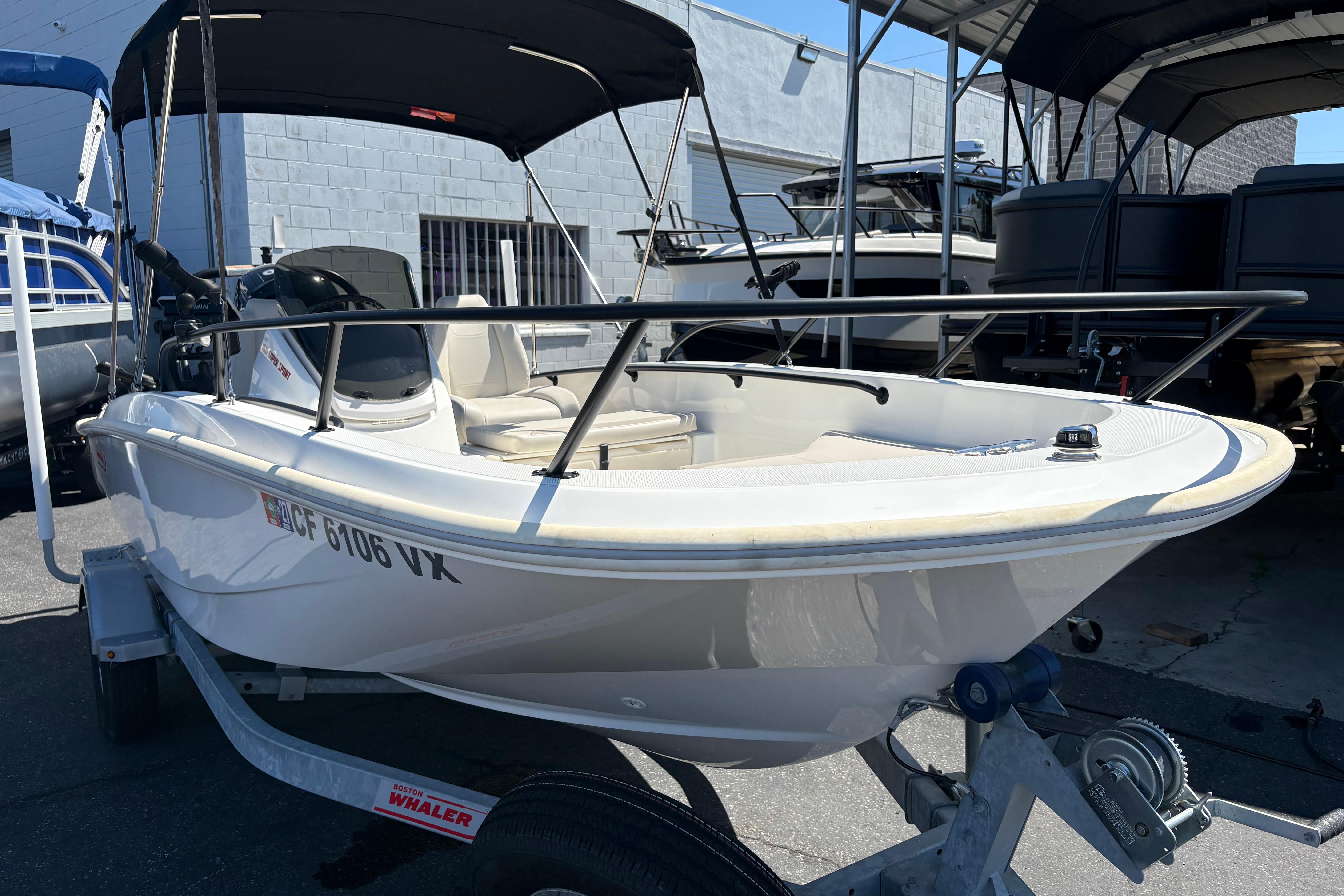 2024 Boston Whaler 160 Super Sport boat on trailer, parked outdoors.