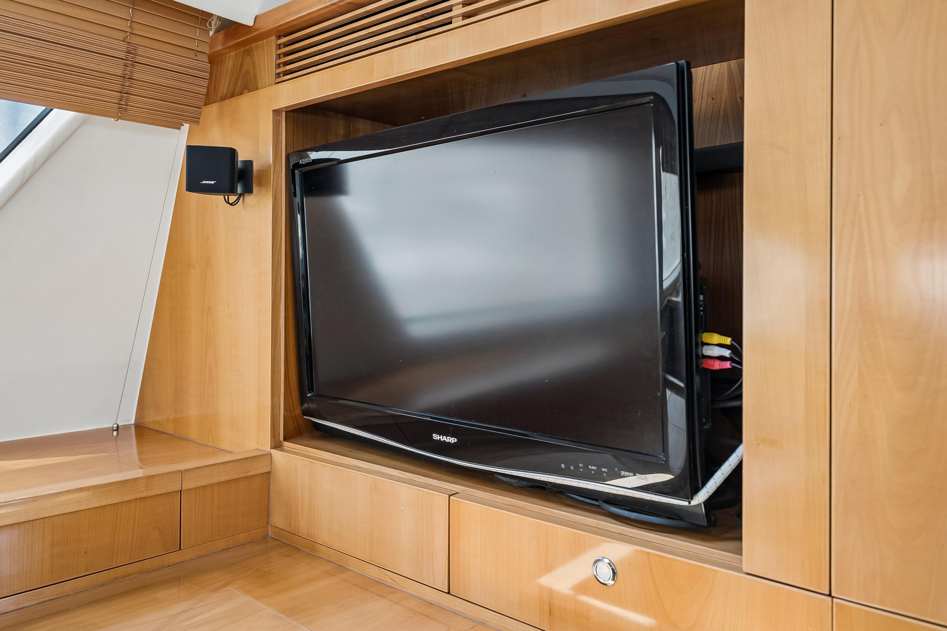 Flat-screen TV in wooden cabinet on 2009 Catana 65 yacht interior.