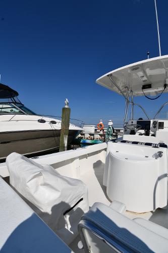 2021 Eastern 248 Center Console boat docked at a marina on a sunny day.