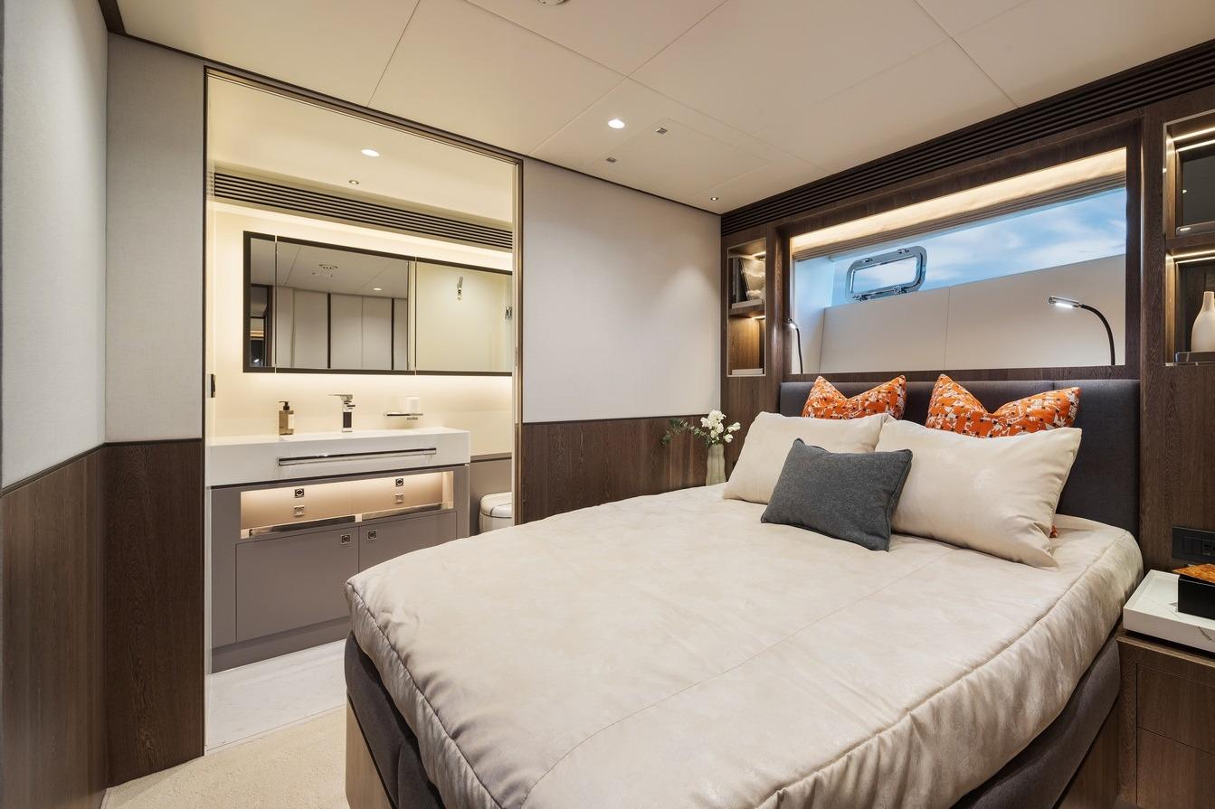 Luxurious bedroom interior of 2026 Horizon FD80 yacht with modern design and elegant furnishings.