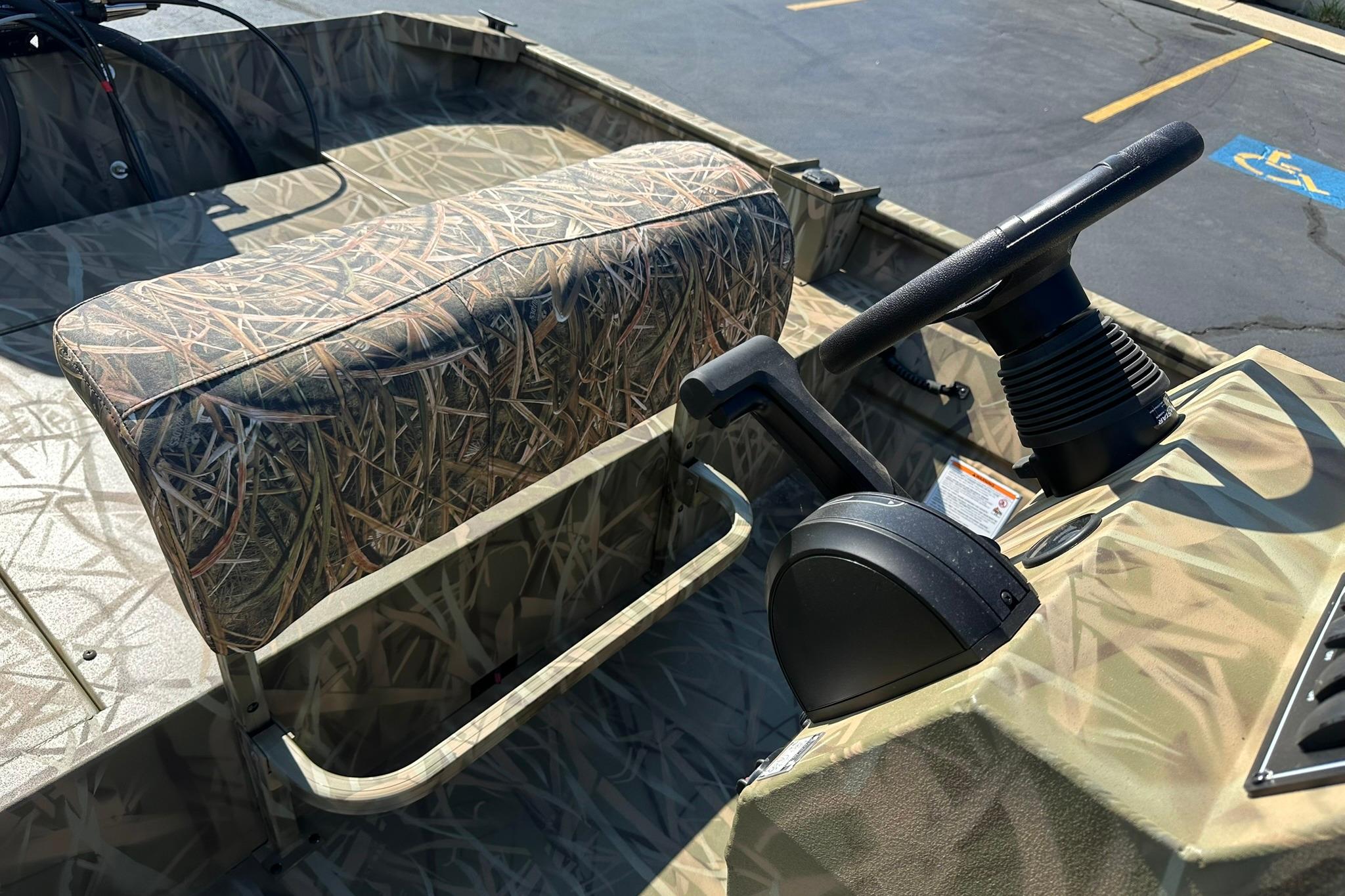 2026 Lowe Roughneck 2070CC boat interior with camo seating and steering console.