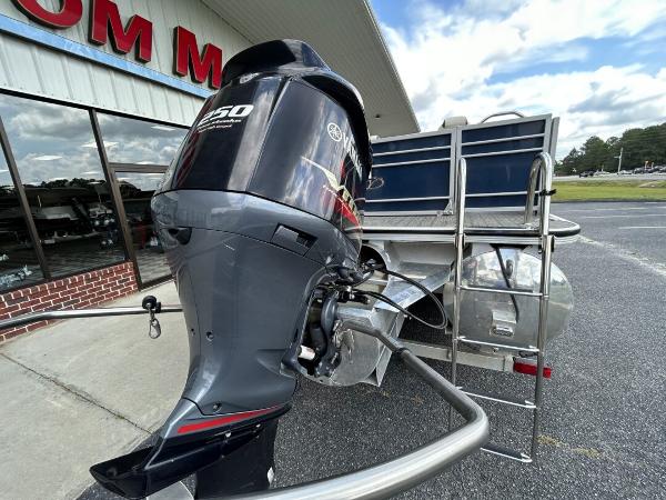 2020 Veranda VP22VLC with outboard motor in parking lot.