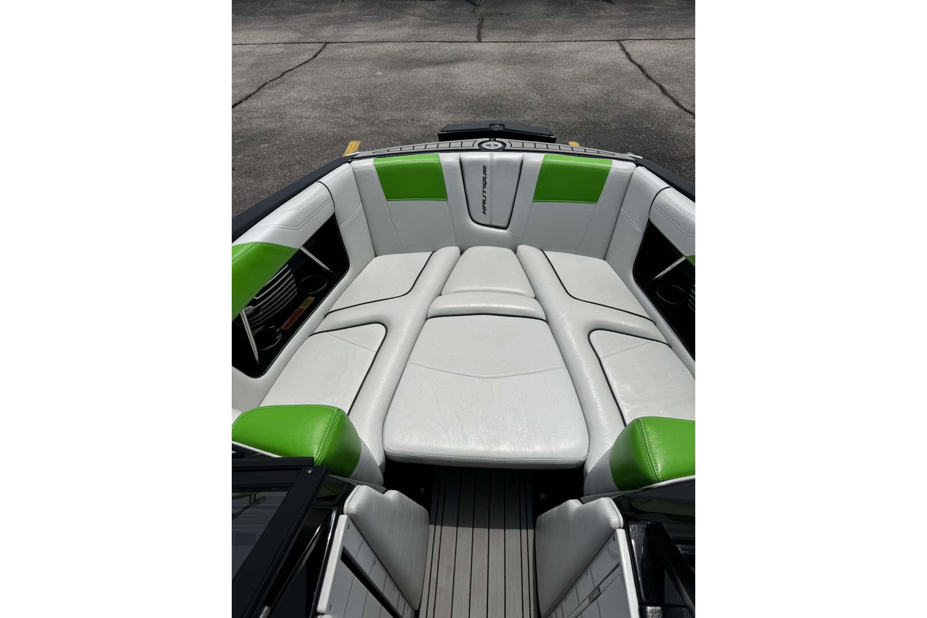 2014 Nautique Super Air Nautique G21 boat interior with white and green seating.