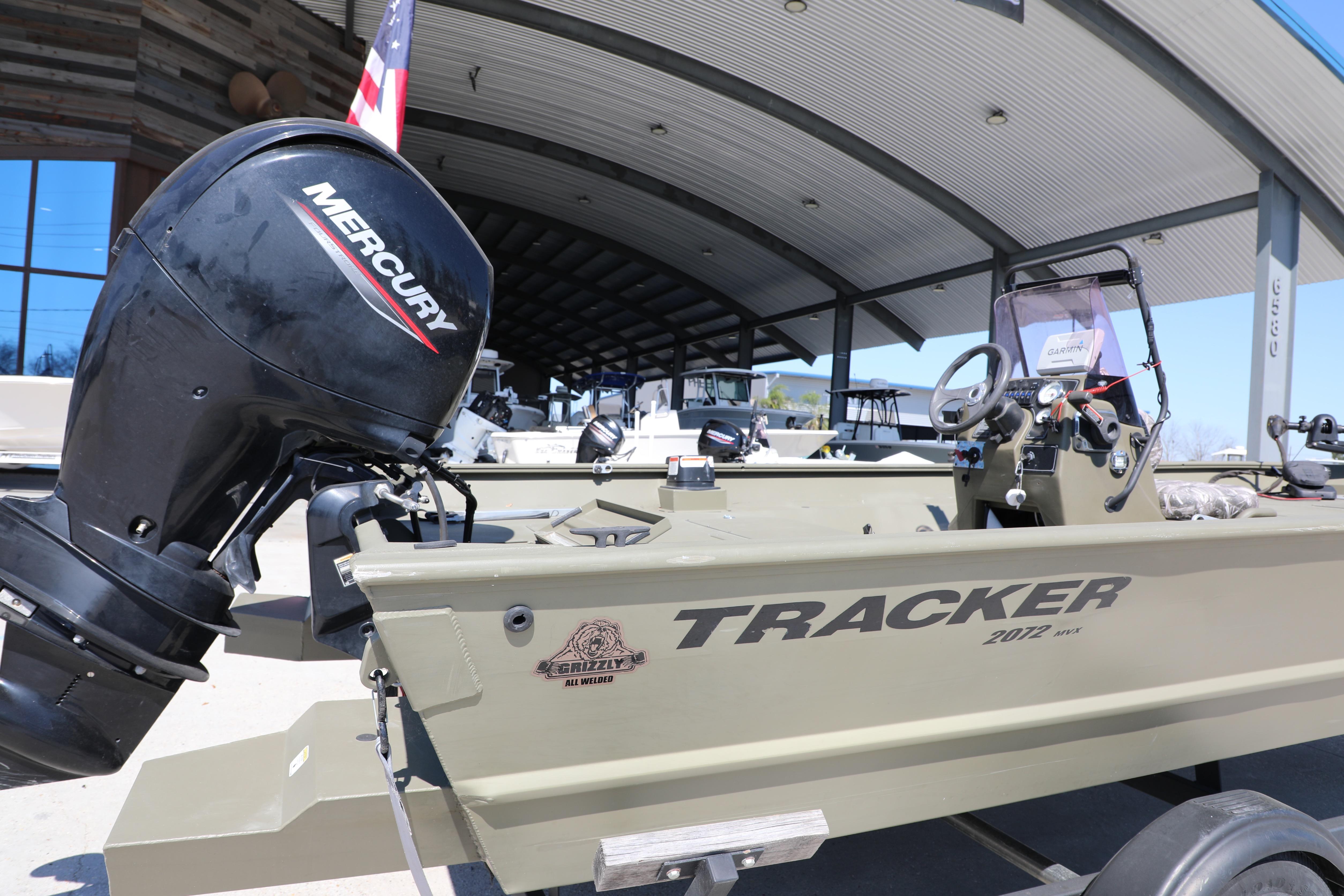 2021 Tracker Grizzly 2072 SC All-Welded boat with Mercury engine displayed outdoors.