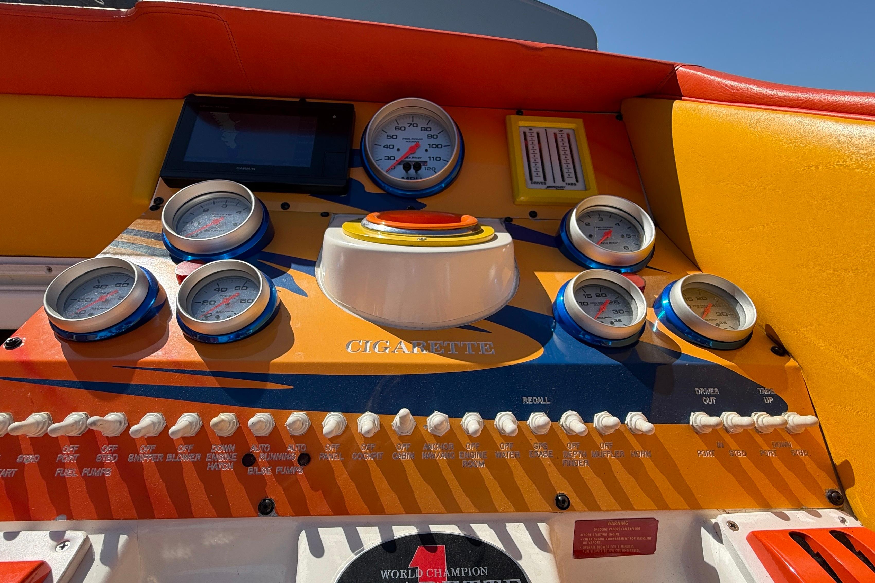 Dashboard of a 2002 Cigarette 35' Cafe Racer boat with colorful gauges and controls.