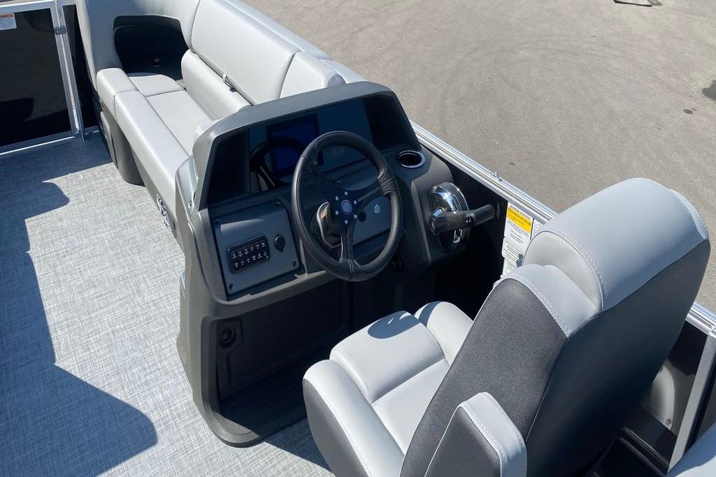 2026 Sun Tracker Party Barge 22 DLX interior with steering console and seating.