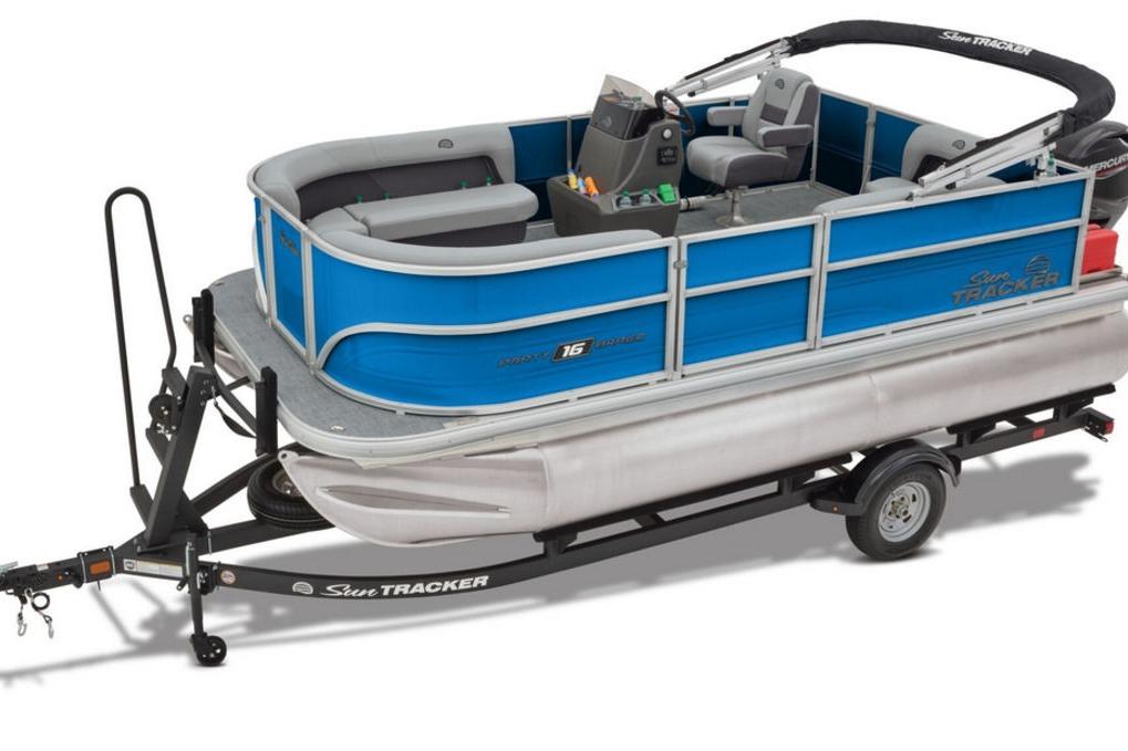 2026 Sun Tracker Party Barge 16 DLX pontoon boat on trailer, blue and silver design.