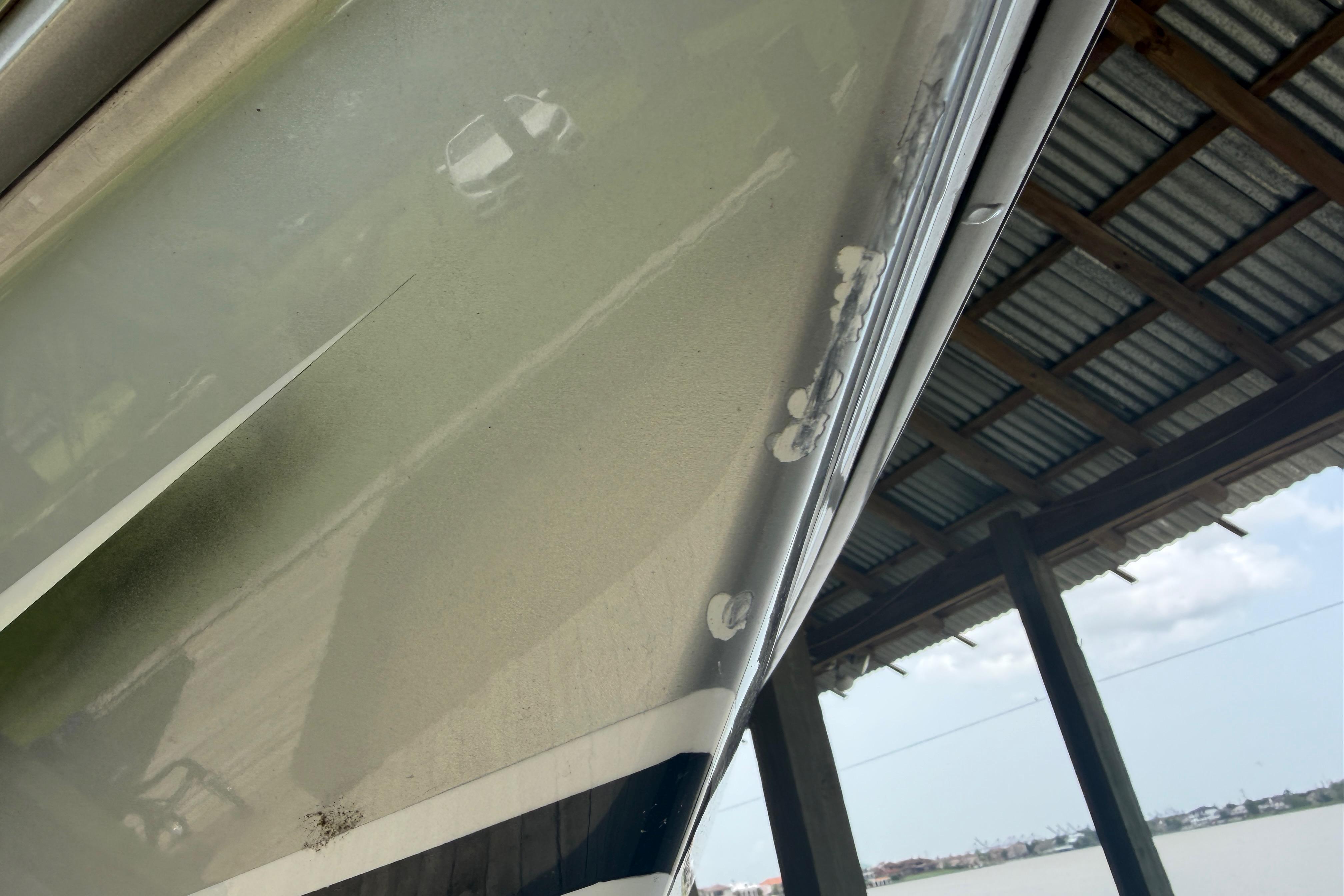 Close-up of 2013 Nor-Tech 477 SPX Vee Bottom hull under a metal roof.