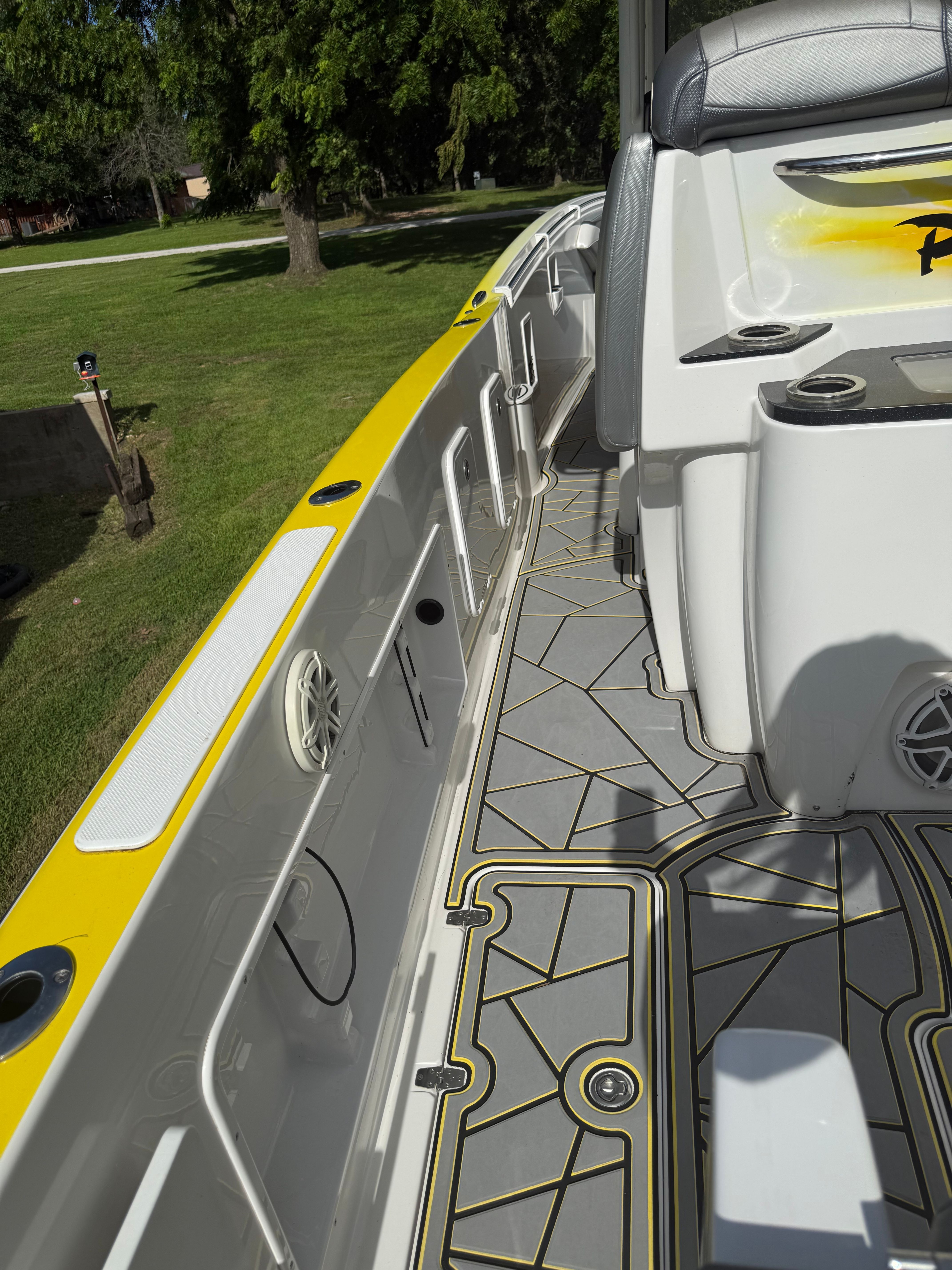 The image shows the deck of a 2014 Sunsation 34 CCX boat with yellow accents.
