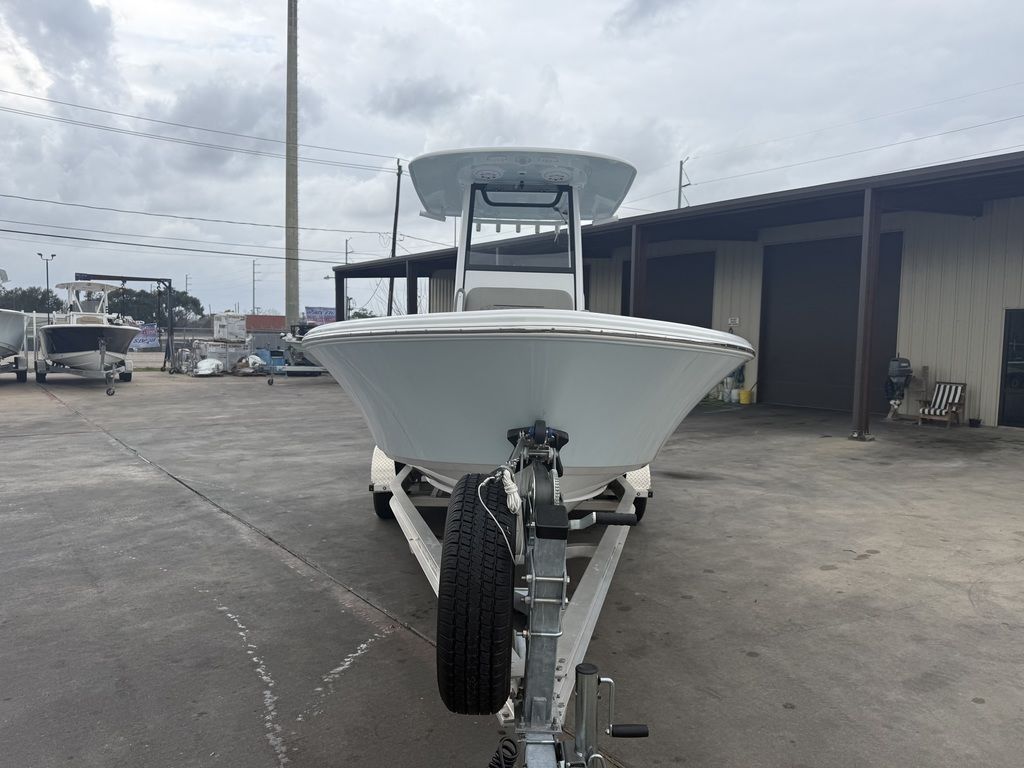 A 2025 Sportsman Masters 247OE Bay Boat on a trailer in a dock area.