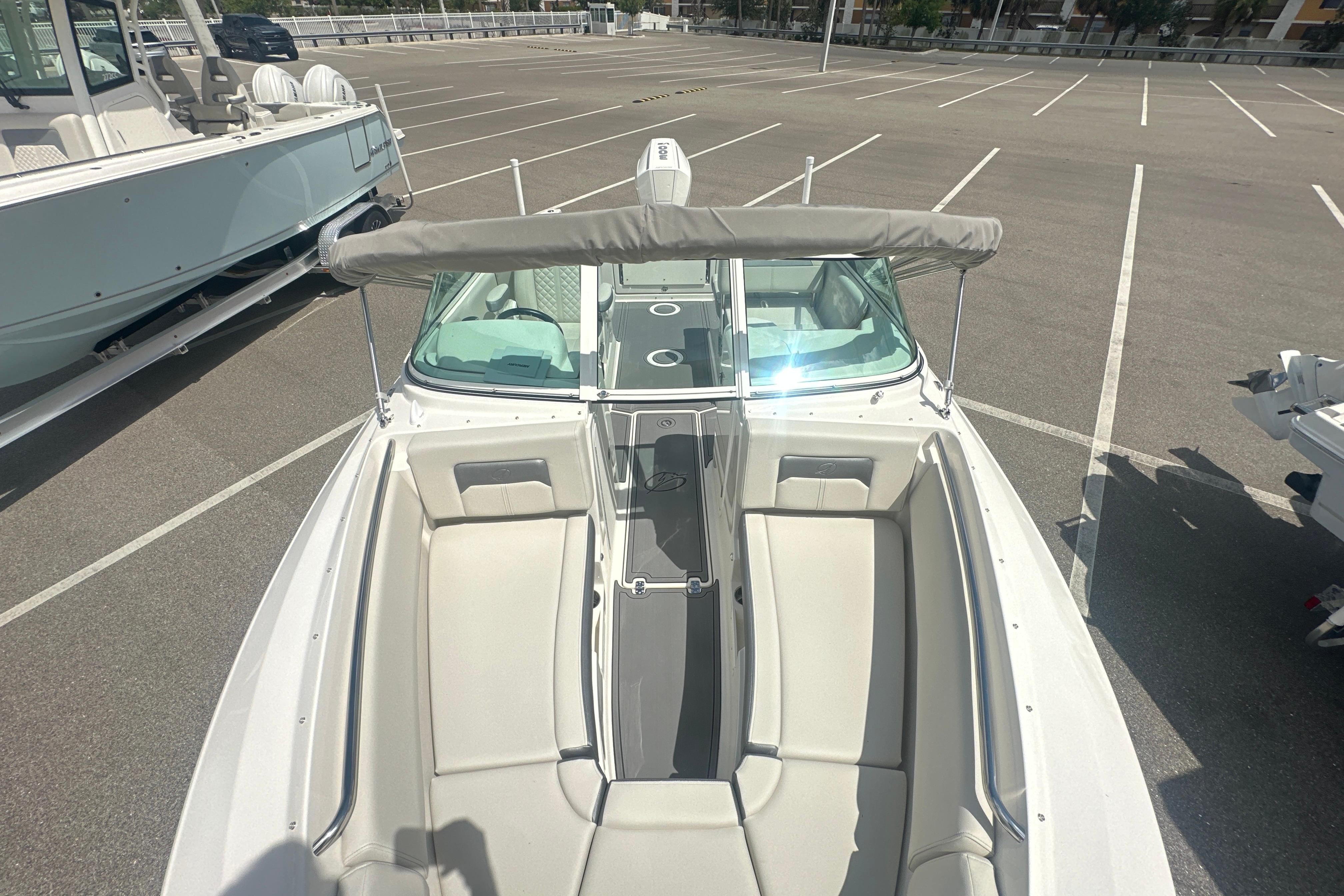 2026 Sailfish 226 DC boat with spacious seating, parked in an empty lot.