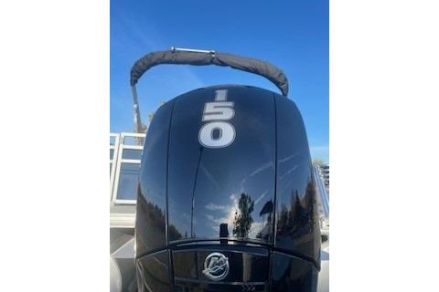 2026 Sun Tracker SportFish 22 XP3 boat engine with 150 horsepower, under clear blue sky.