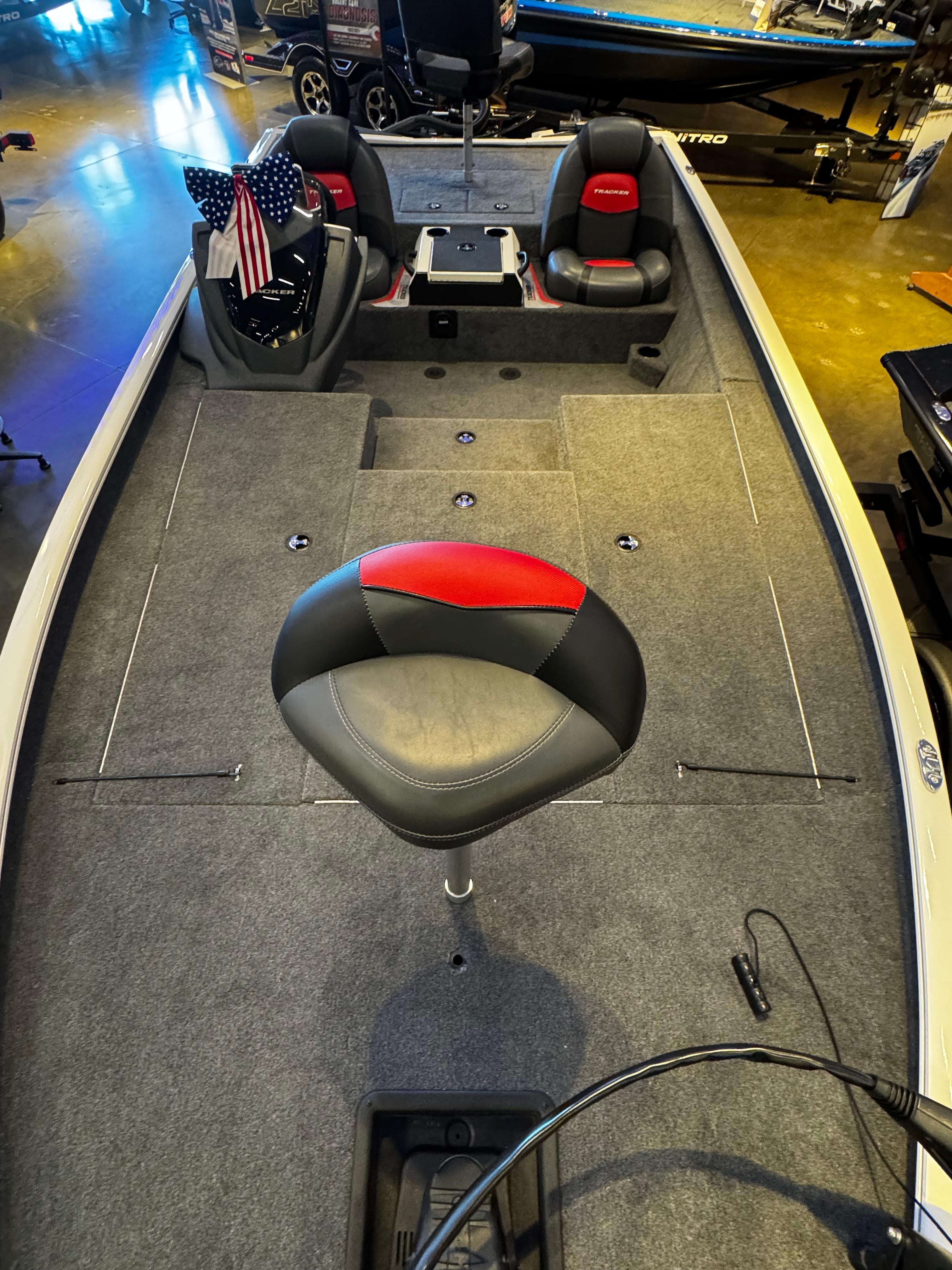 2025 Tracker Savage 215 boat interior with seating and carpeted deck.