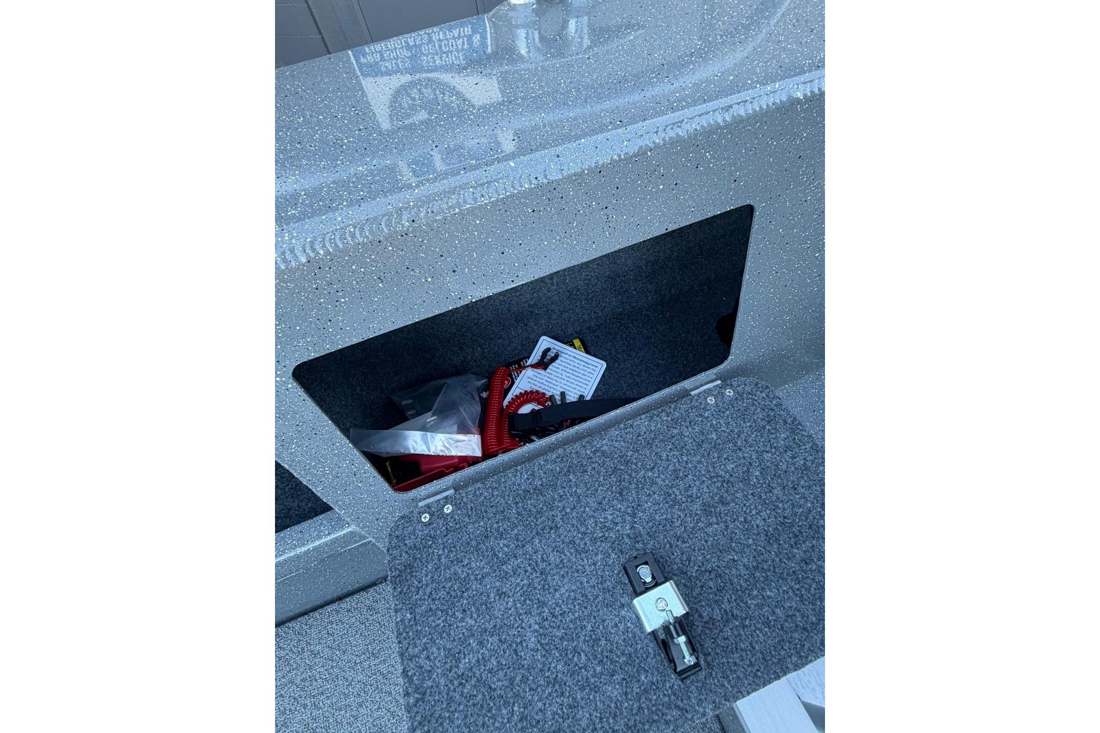 Storage compartment in 2026 Thunder Jet 209 Rush OT boat, featuring safety equipment.