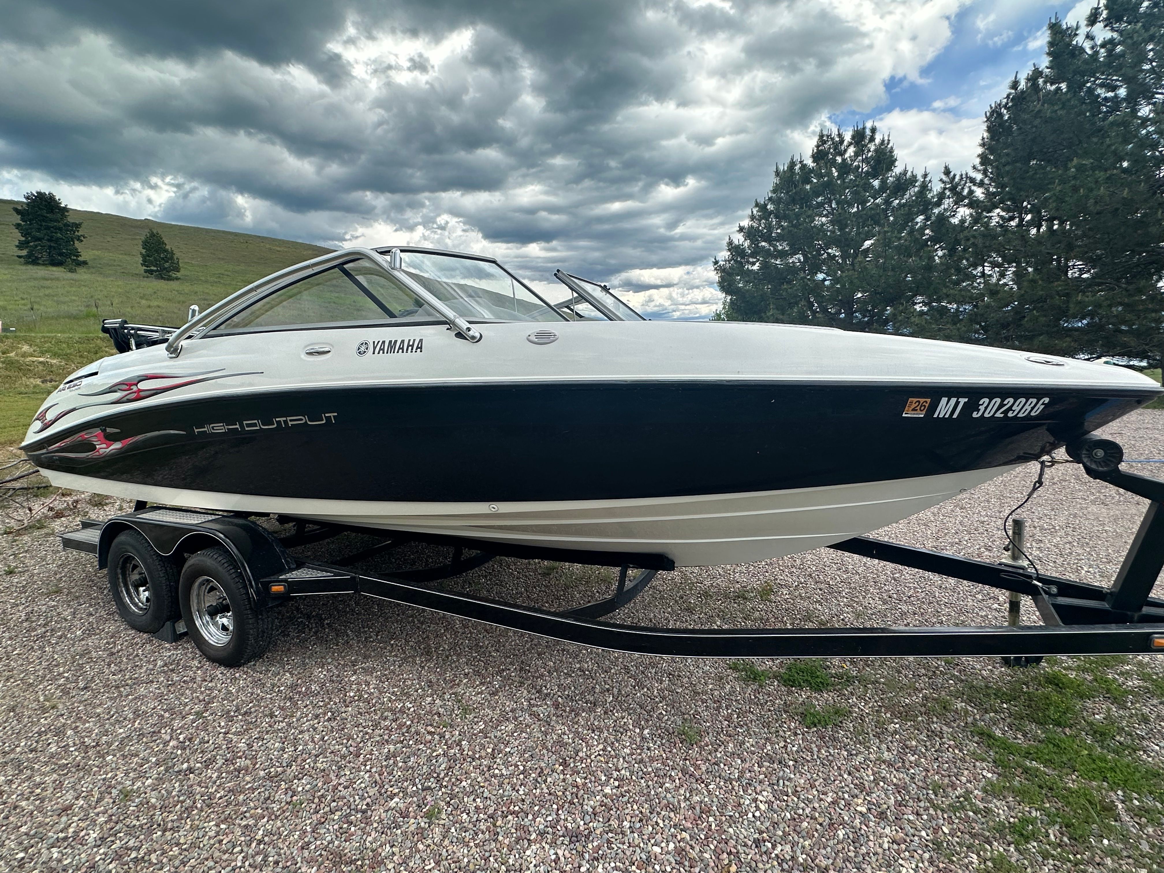 2005 Yamaha AR230 HO boat on trailer, cloudy sky.