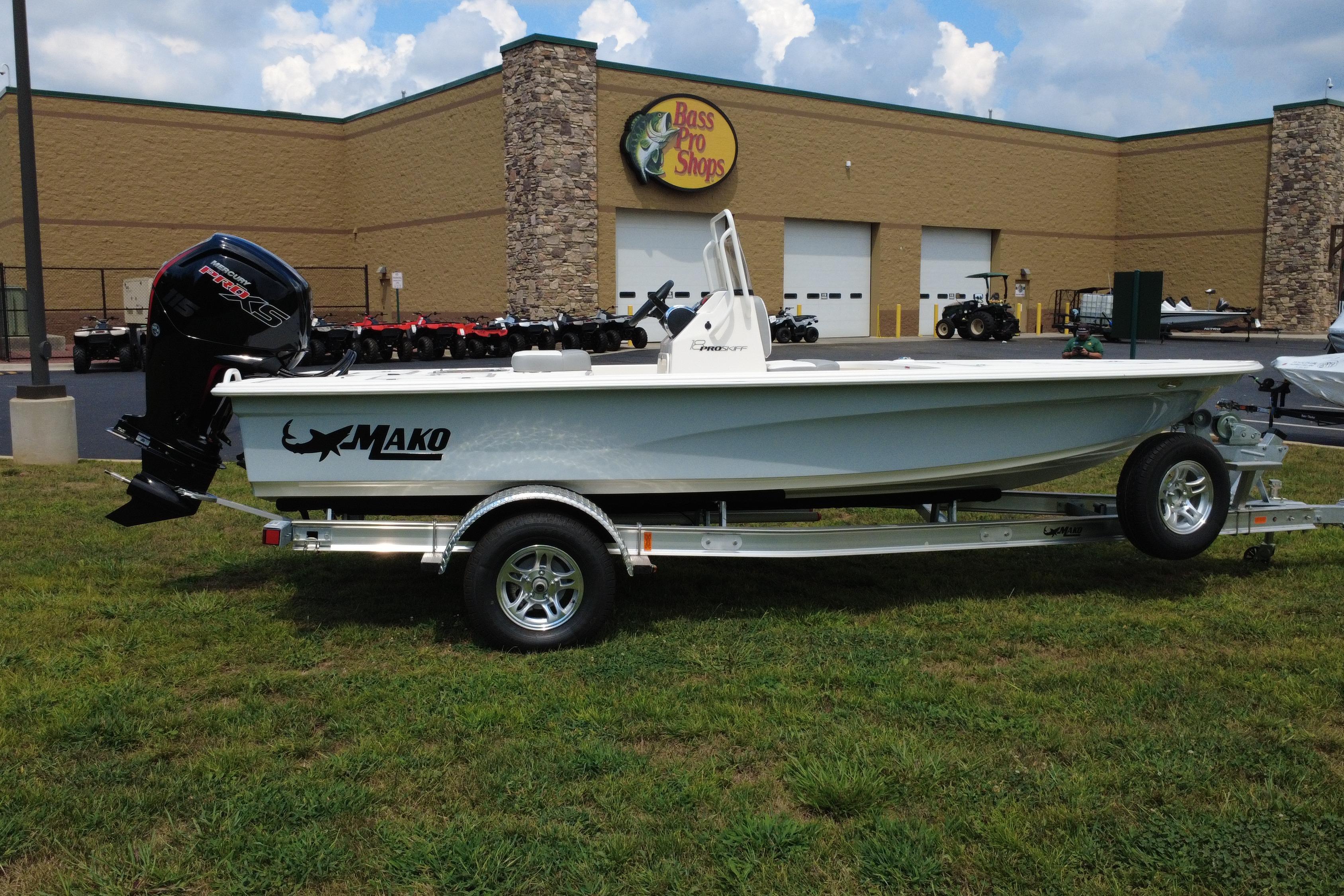 2026 Mako 18 Pro Skiff boat on trailer outside Bass Pro Shops.