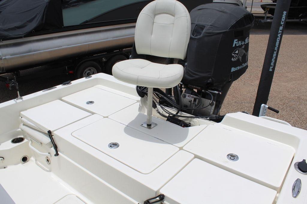 2026 Skeeter SX230 boat with cushioned seat and outboard motor, ideal for fishing.