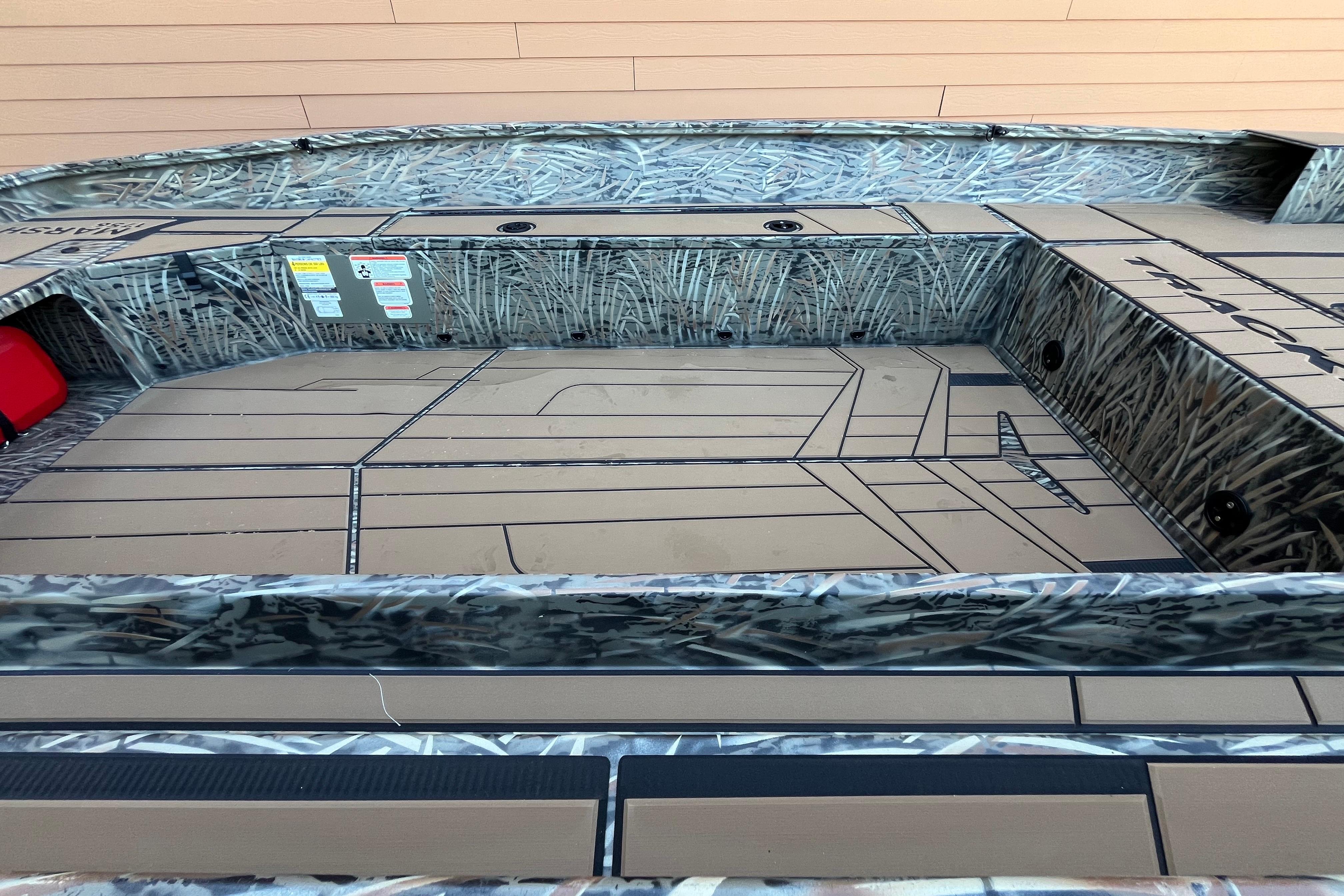 2026 Tracker Grizzly 1756 T Marsh boat interior with camouflage design and spacious deck.