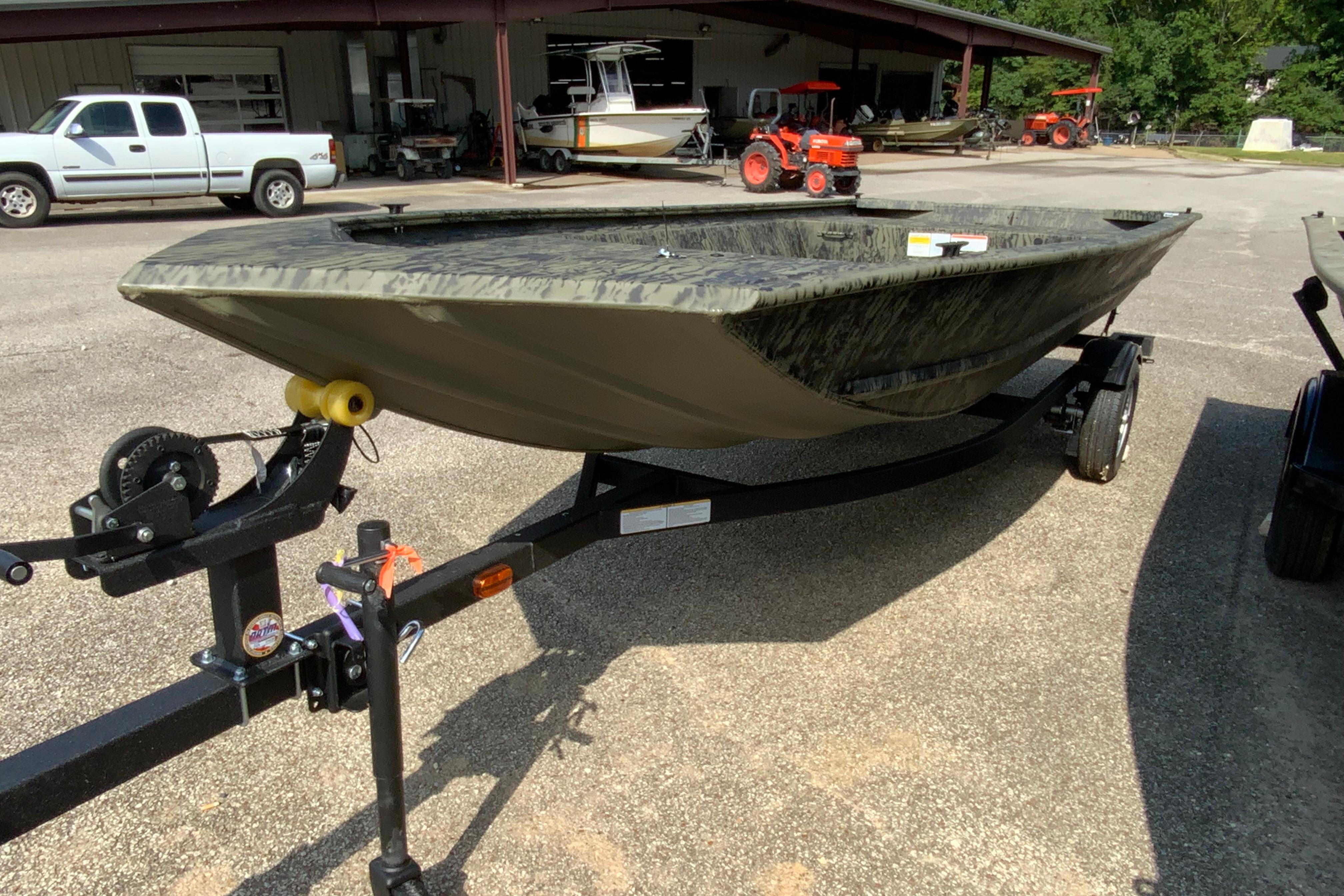 2026 Tracker Grizzly 1648 Utility boat on trailer, parked outdoors.