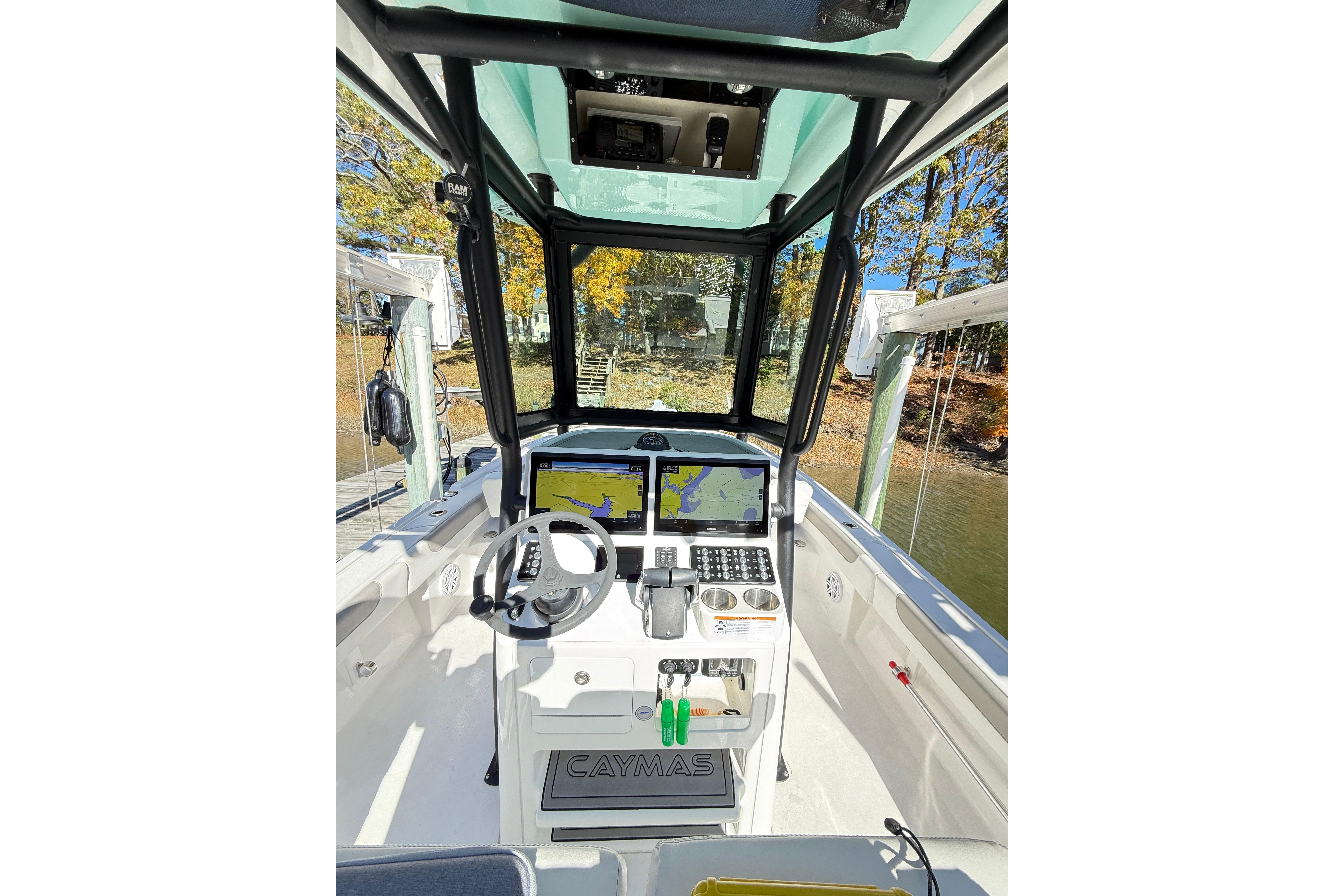 2023 Caymas 281 HB boat cockpit with advanced navigation system and steering wheel.