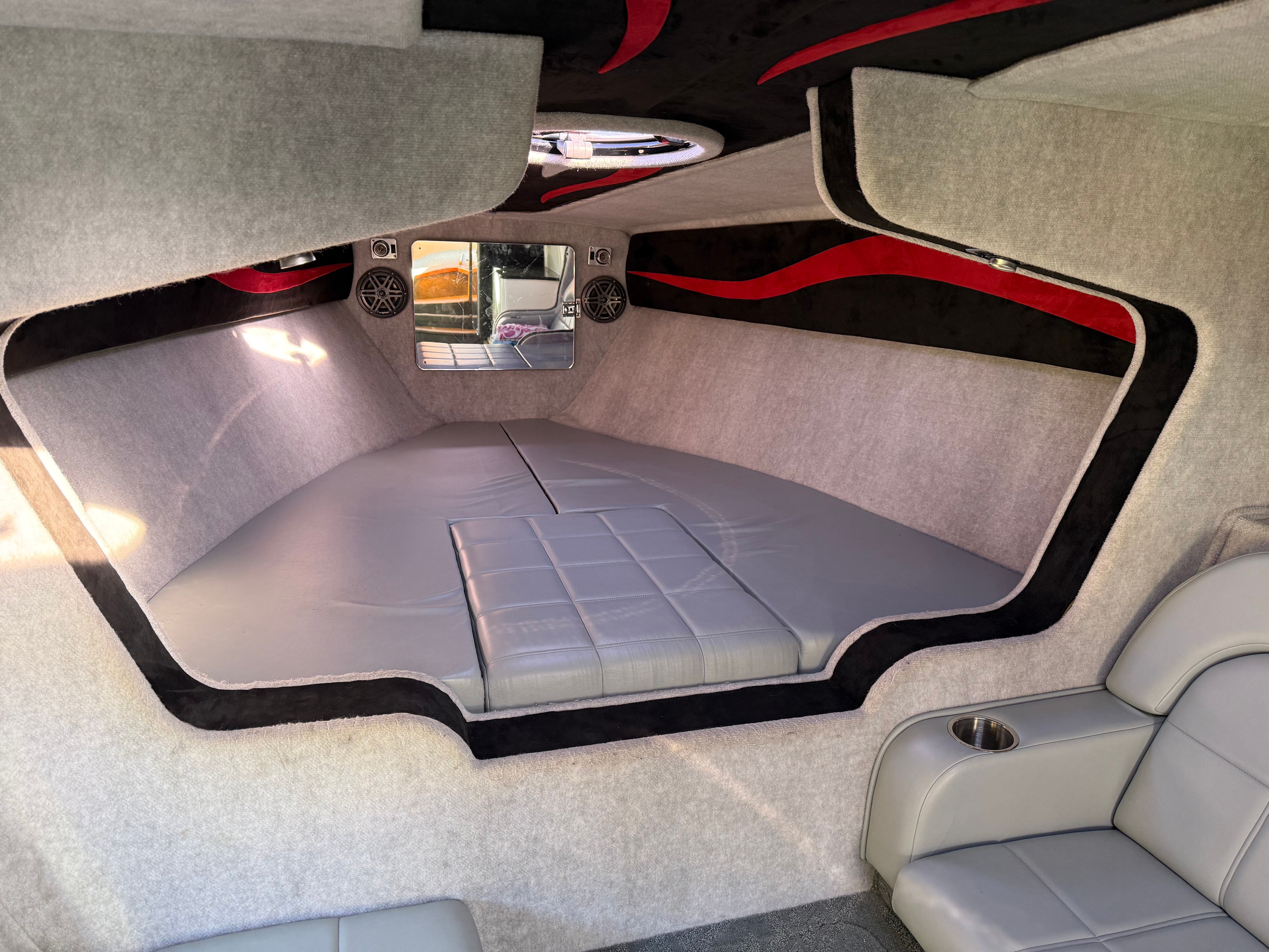 Interior of a 2009 Hallett 400T boat with gray upholstery.