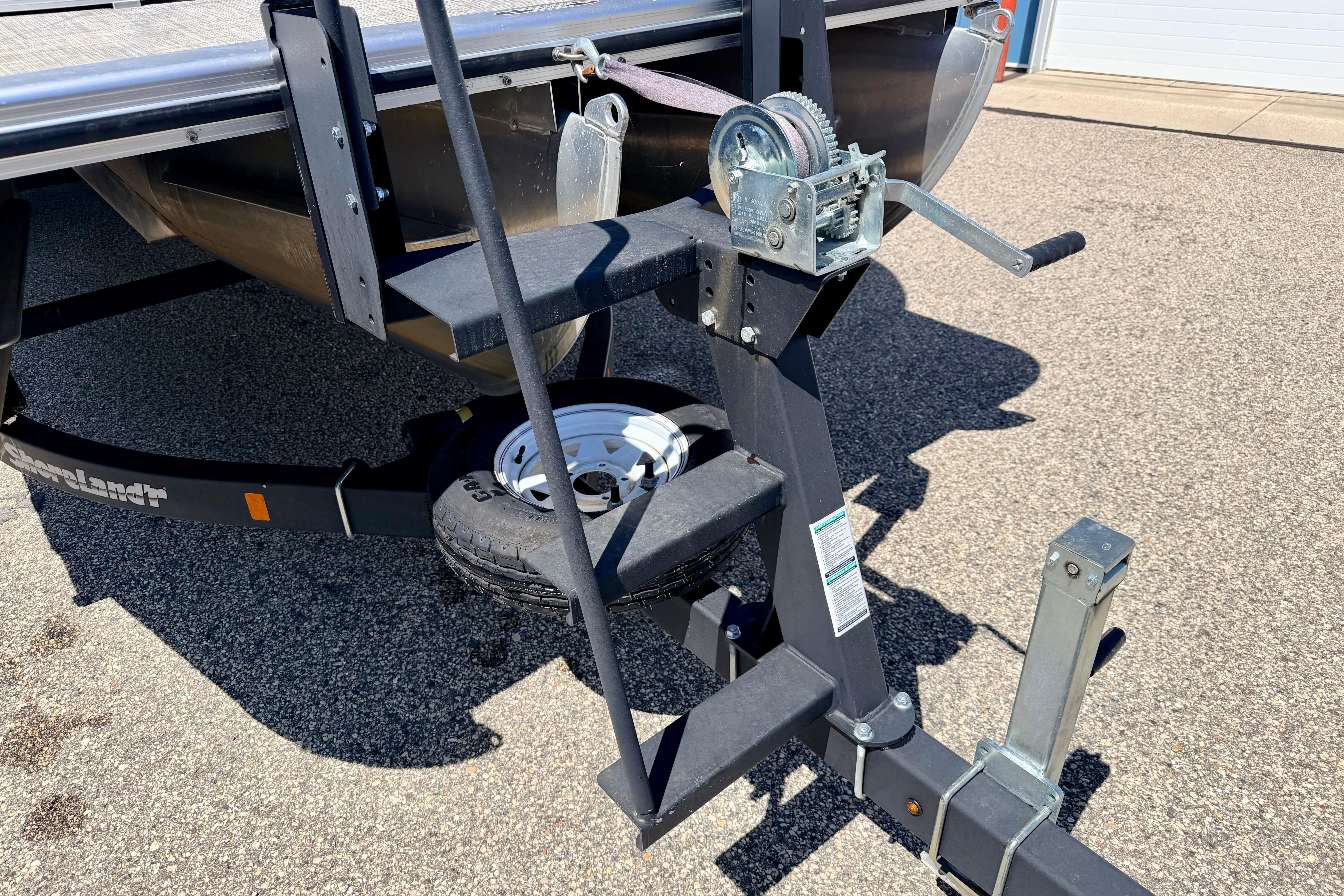 Trailer hitch and winch of 2019 Crestliner 240 Rally DX CW boat on pavement.