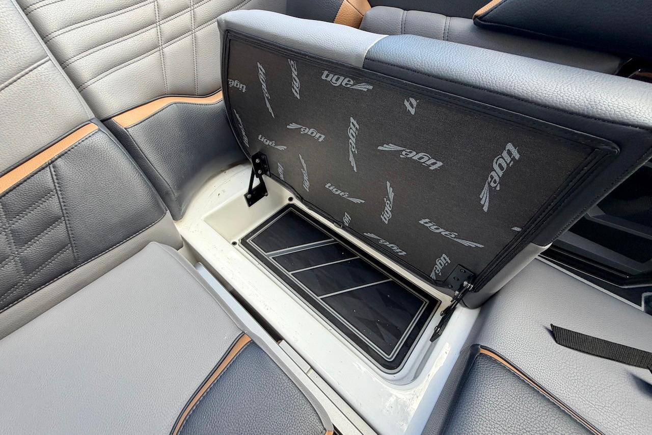 2025 Tigé Ultré 25ZX boat interior storage compartment with open seat cushion.