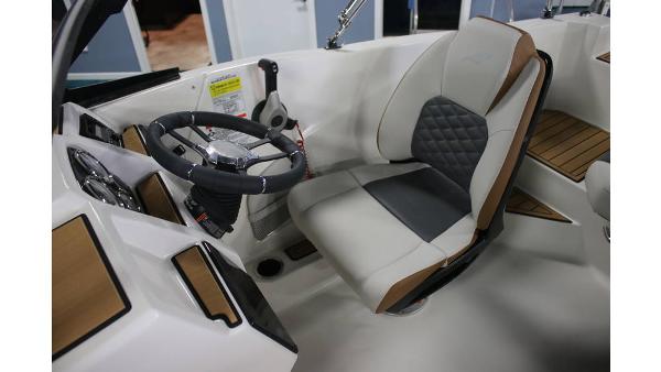2025 Starcraft SVX 190 OB DC boat interior with steering wheel and cushioned seat.