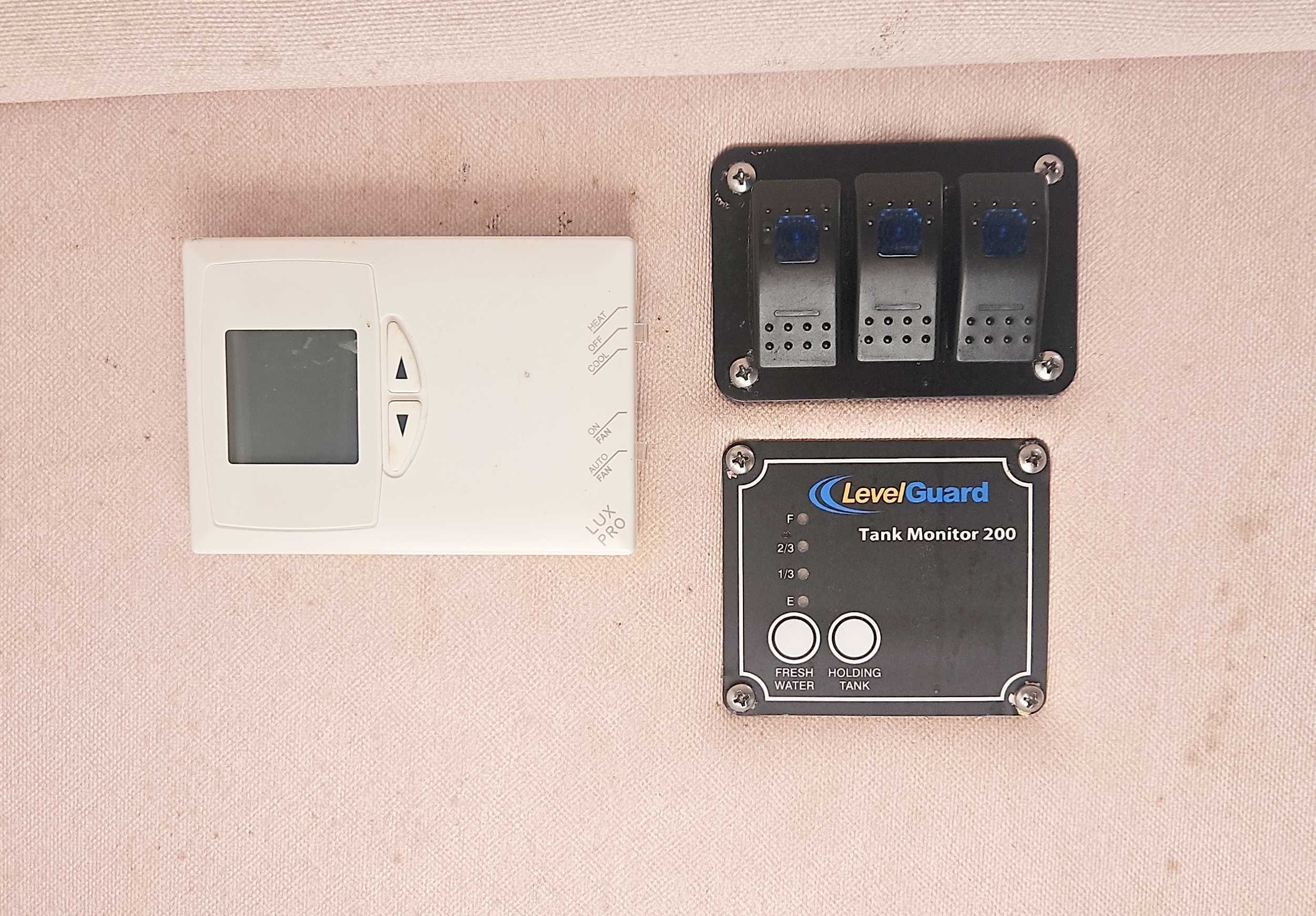 Electronic controls and a tank monitor on a boat.