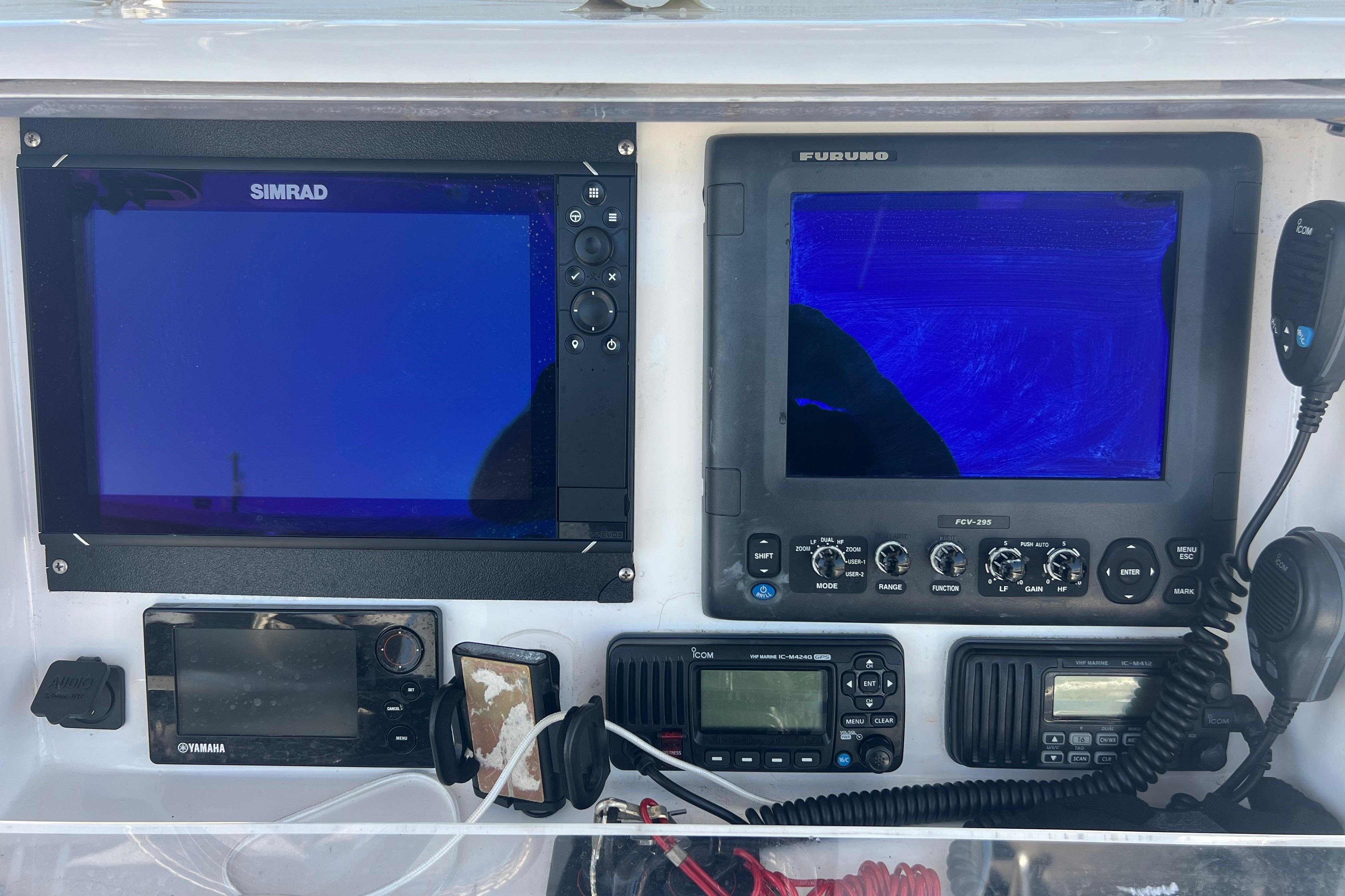 Control panel of a 2012 Invincible 33 Open Fisherman with Simrad and Furuno displays.
