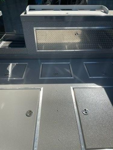 2025 Spartan 2600 Olympia boat deck with storage compartments and metallic finish.
