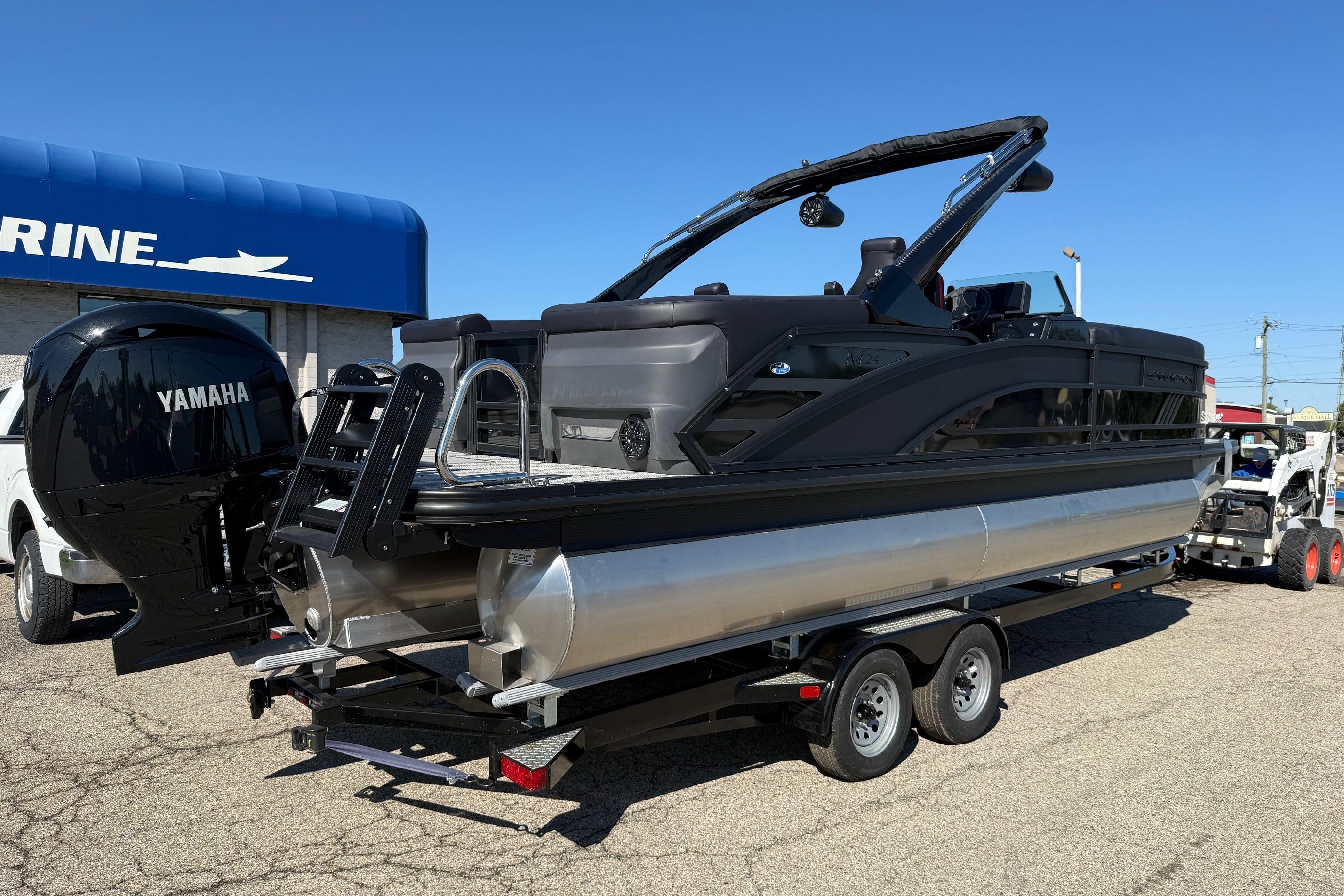 2025 Bennington M Line pontoon boat with Yamaha engine on trailer.
