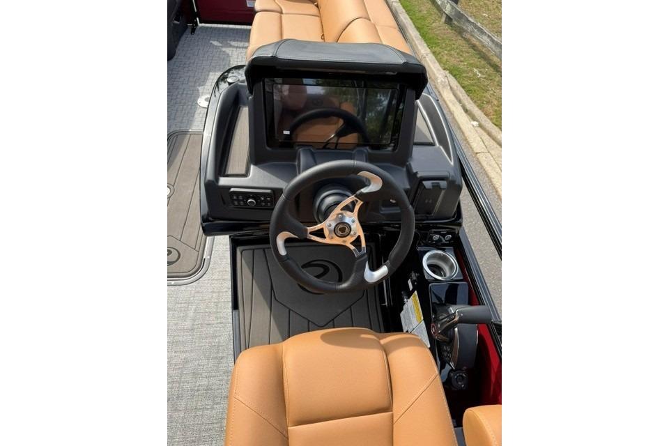 2026 Regency 230 DL boat cockpit with modern steering wheel and dashboard display.