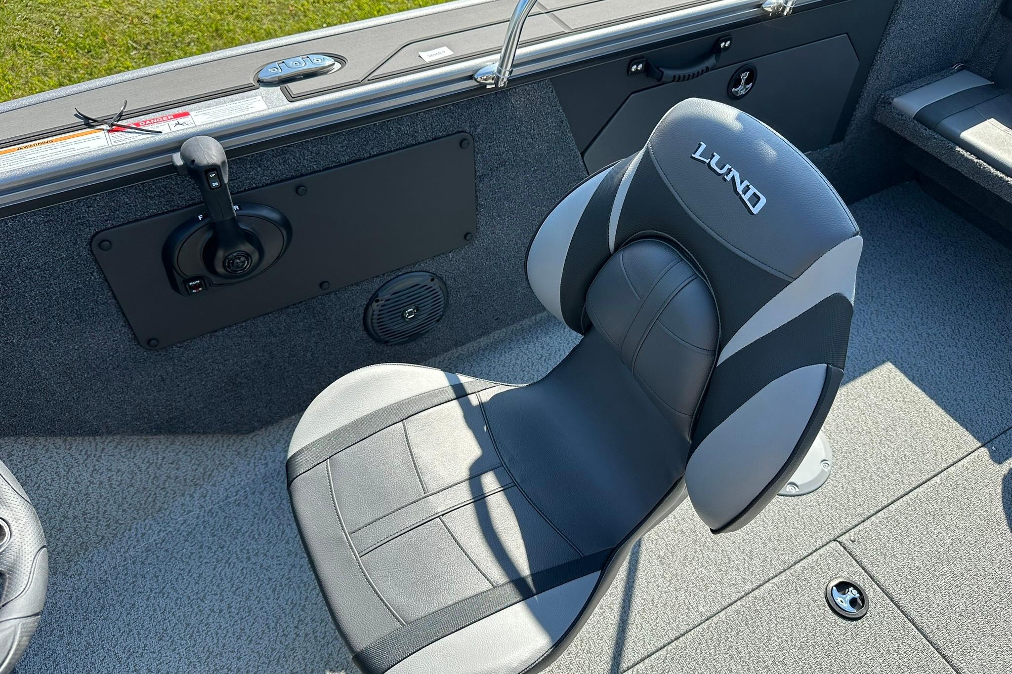 2026 Lund 1875 Fisherman boat interior with a comfortable, branded seat and control panel.