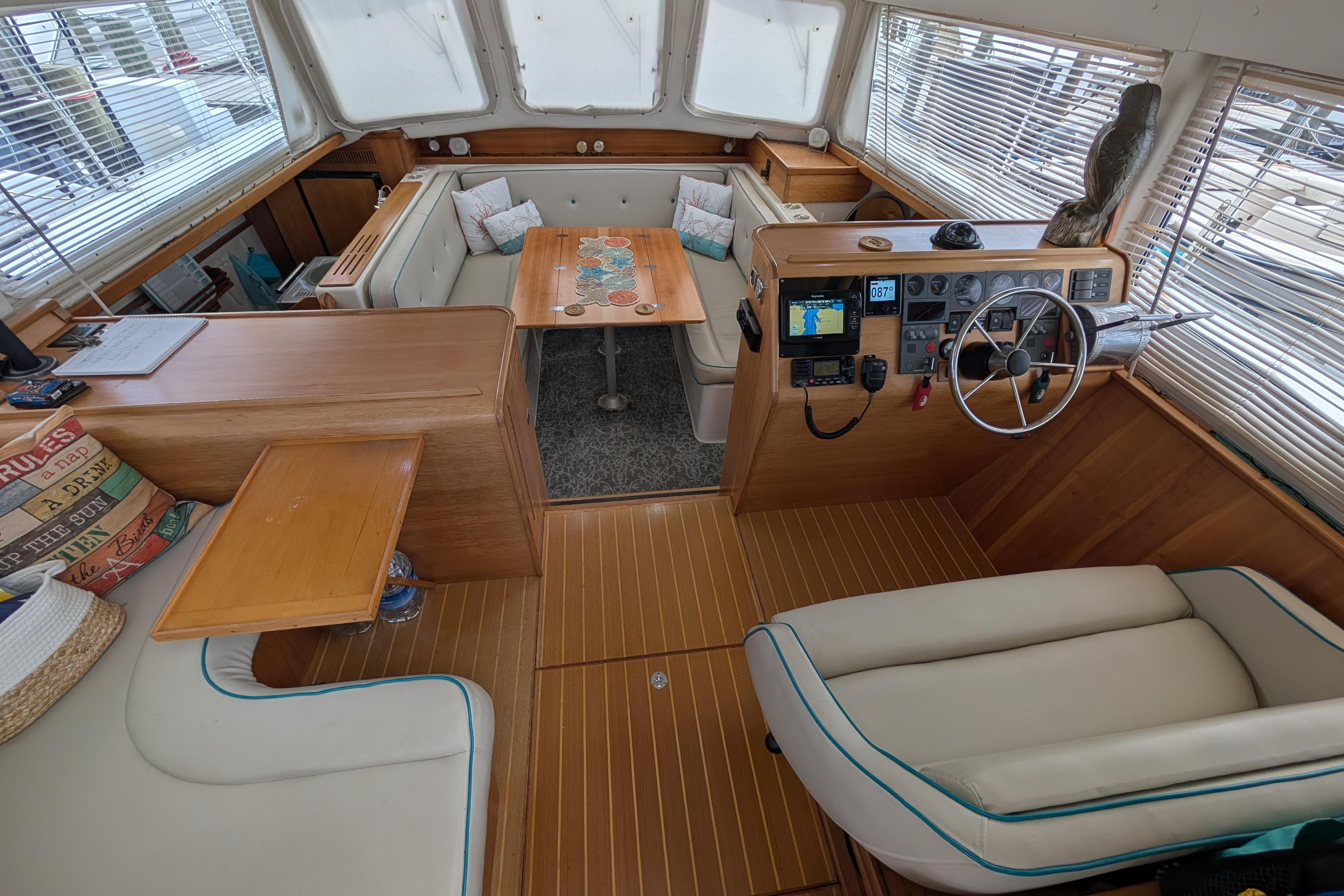 Interior of 2004 PDQ 34 Powercat boat with helm, seating, and navigation equipment.