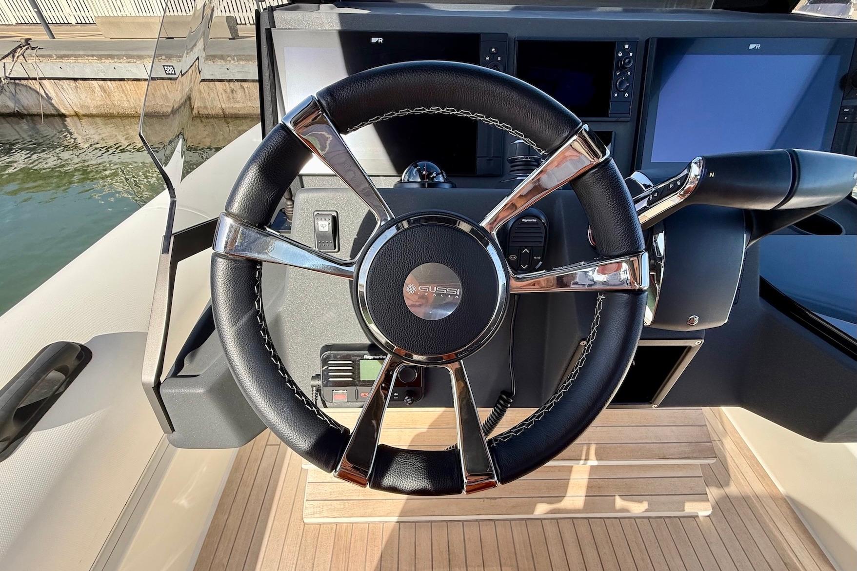 Steering wheel of 2025 Technohull 38 Grand Sport boat, featuring modern dashboard design.