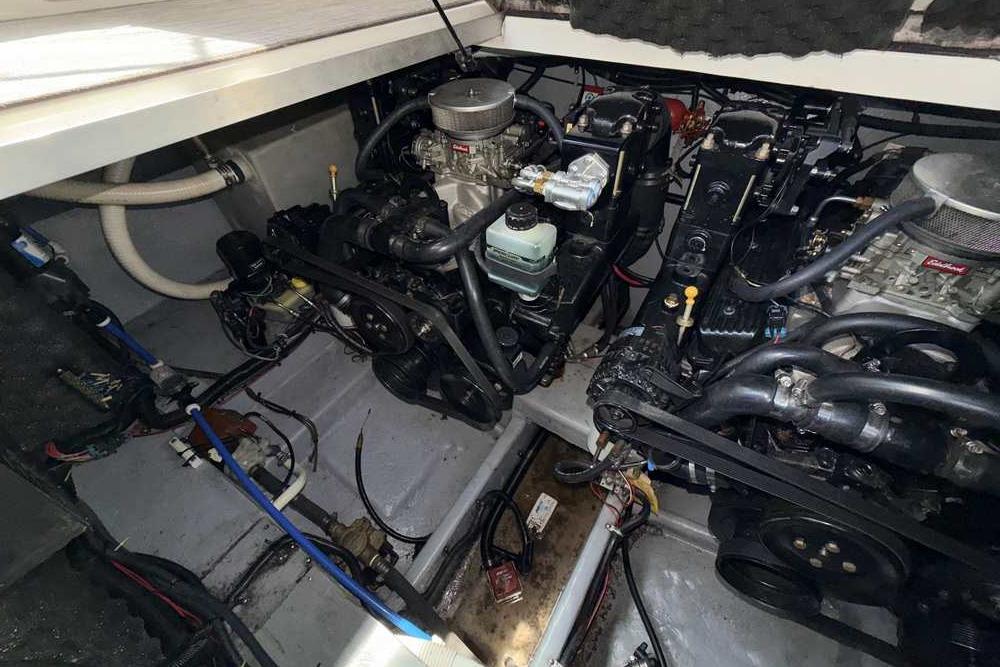 Engine compartment of a 2001 Monterey 282 Cruiser boat, showcasing dual engines and components.