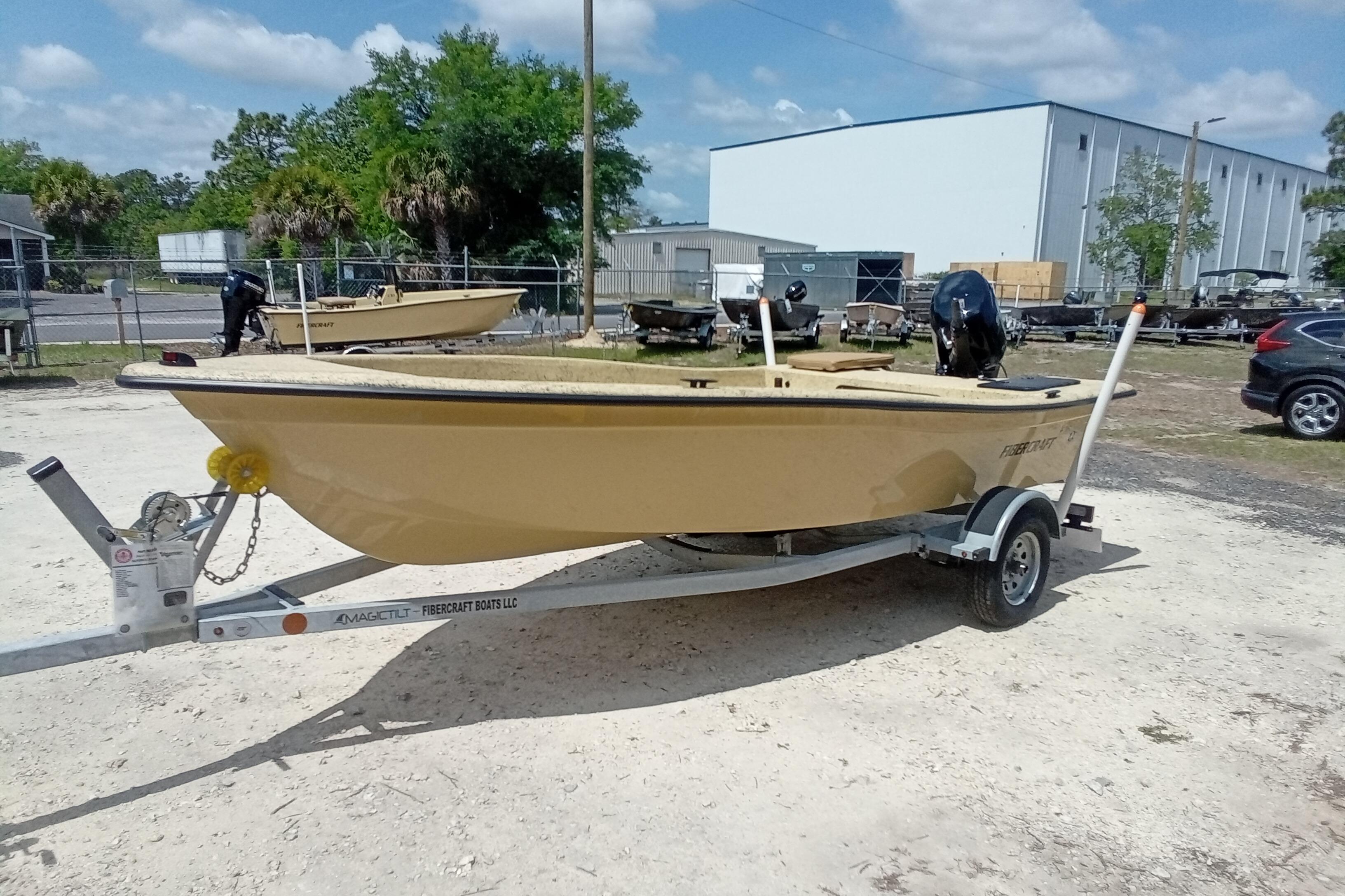 2025 Fibercraft F16 boat on trailer in outdoor lot, sunny day.