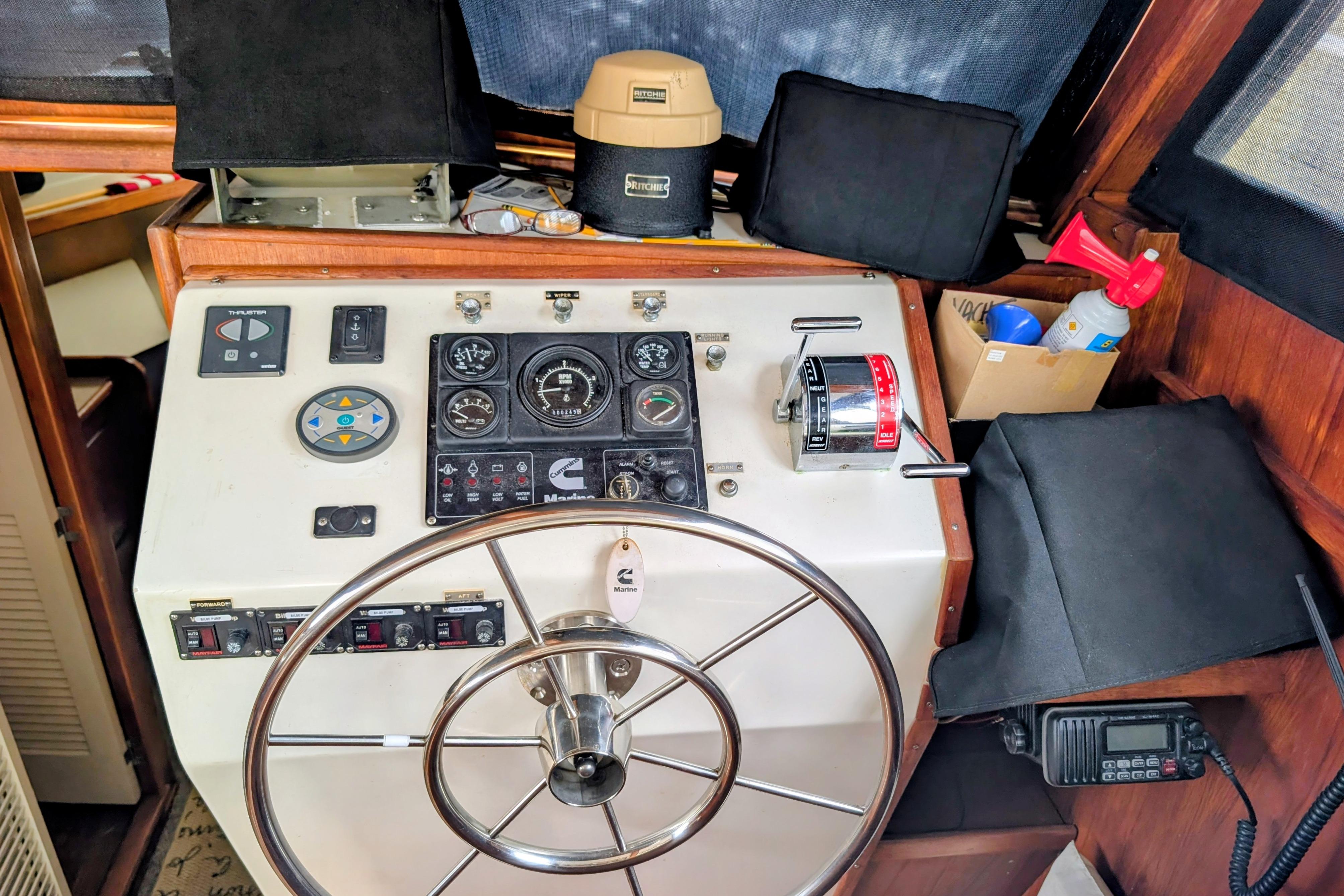 Helm of 1998 Markley 46 boat with steering wheel and control panel.